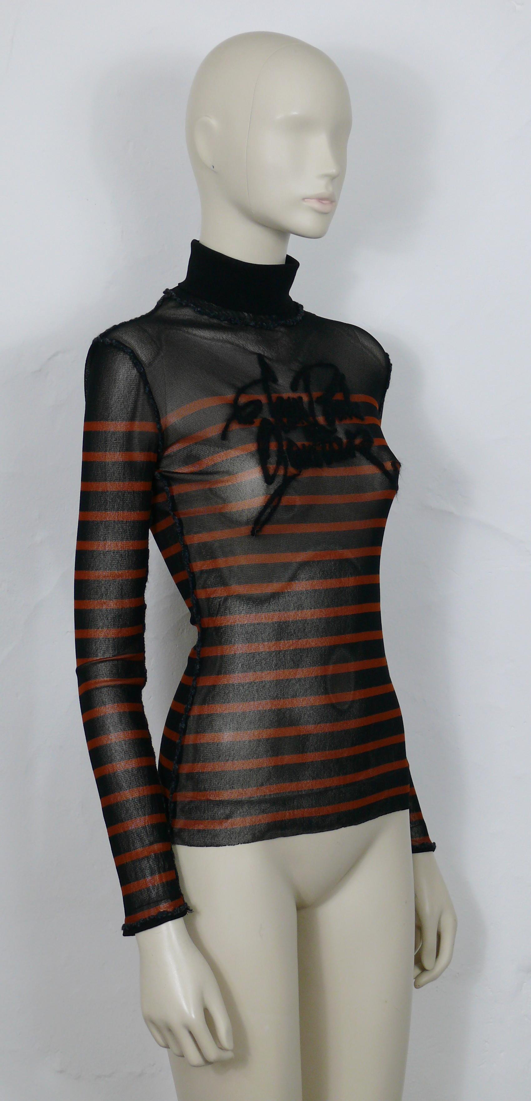 JEAN PAUL GAULTIER vintage black with brick color stripes sheer mesh matelot top with JEAN PAUL GAULTIER cursive signature.

Turtle neck collar.
Exposed seams.
Long sleeves.

Label reads JEAN PAUL GAULTIER Maille Femme.
Made in Italy.

Missing size