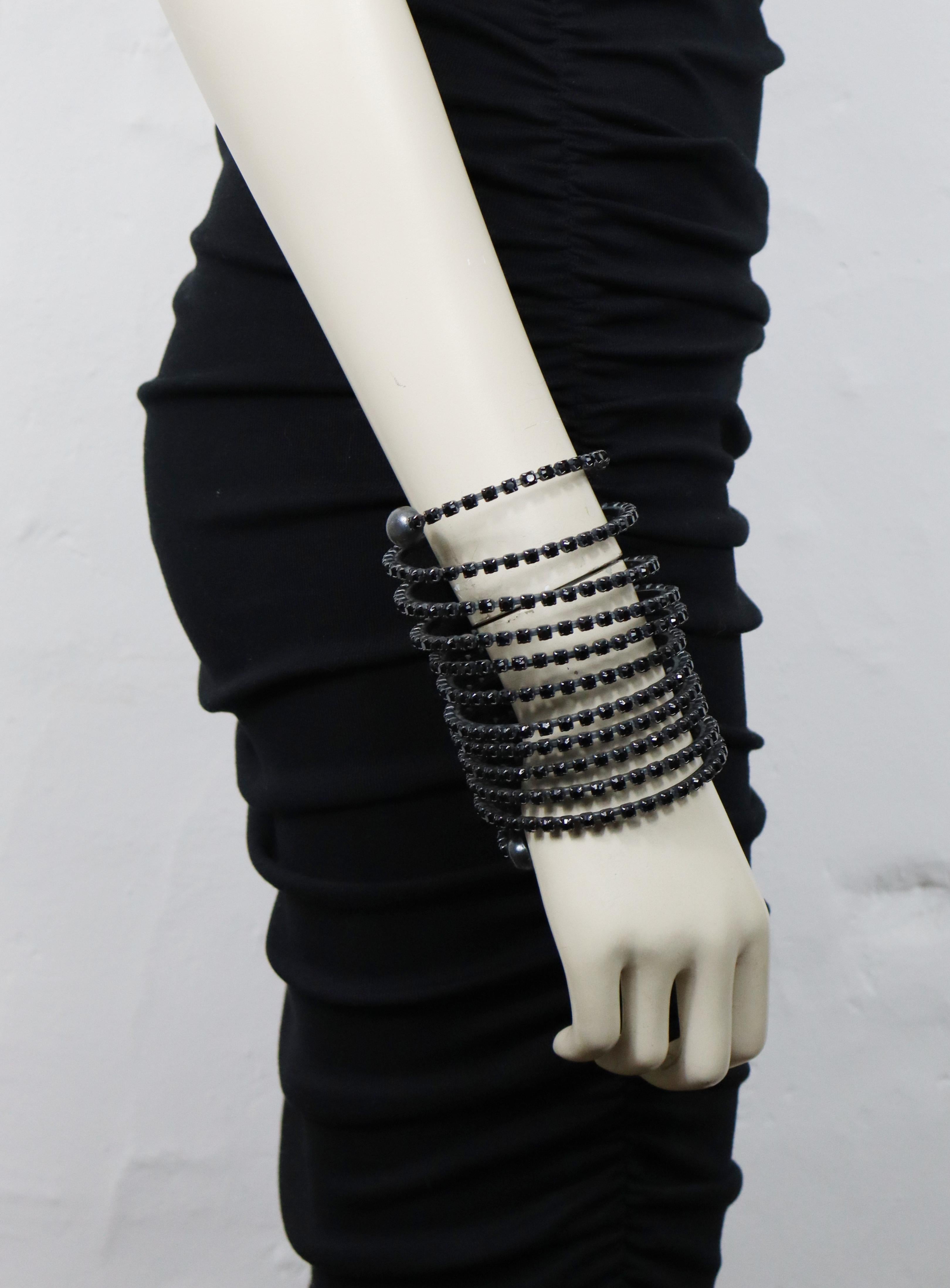 JEAN PAUL GAULTIER vintage maxi gun patina tone metal coil cuff bracelet embellished with black jet crystals.

Slips on (no clasp closure).

Marked GAULTIER.

Indicative measurements : inner circumference approx. 19.48 cm (7.67 inches) / width