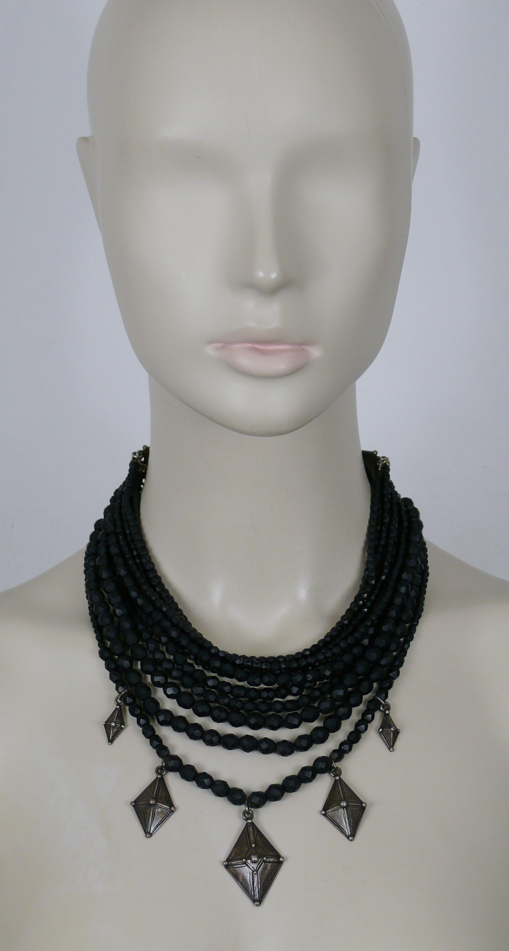 JEAN PAUL GAULTIER vintage ethnic multistrand necklace featuring black matte glass beads, antiqued silver tone hardware and diamond-shaped charms.

Lobster clasp closure.

Marked GAULTIER.

Indicative measurements : adjustable length from approx. 42