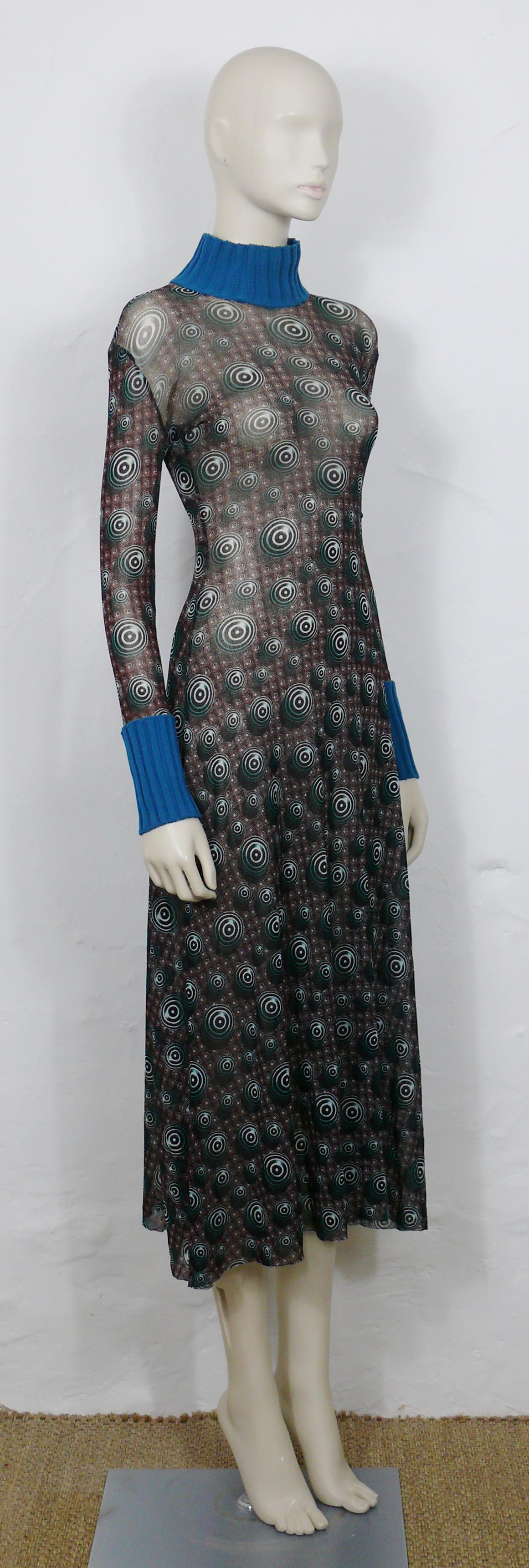 JEAN PAUL GAULTIER vintage sheer mesh dress featuring an opulent abstract Op Art circles print all over.

This jumpsuit features :
- FUZZI sheer mesh.
- Long sleeves.
- Duck blue color knitted collar and cuffs.
- Has stretch.
- Slips on.
-