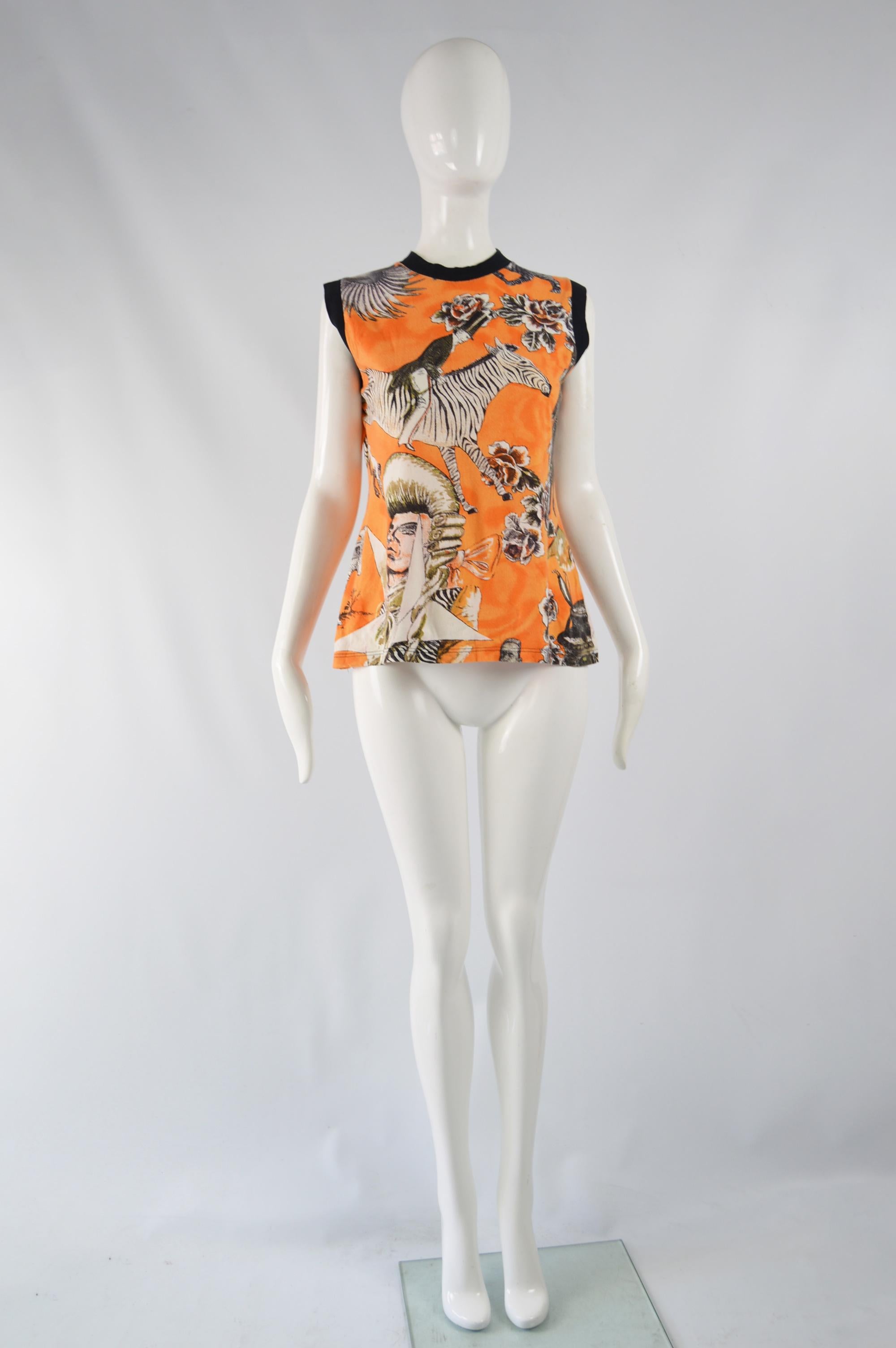 A great vintage women's sleeveless t shirt / tank top from the 80s by iconic French fashion designer, Jean Paul Gaultier. In an orange cotton jersey with a black ribbed trim and an amazing, fun print throughout with crazy, eccentric imagery that