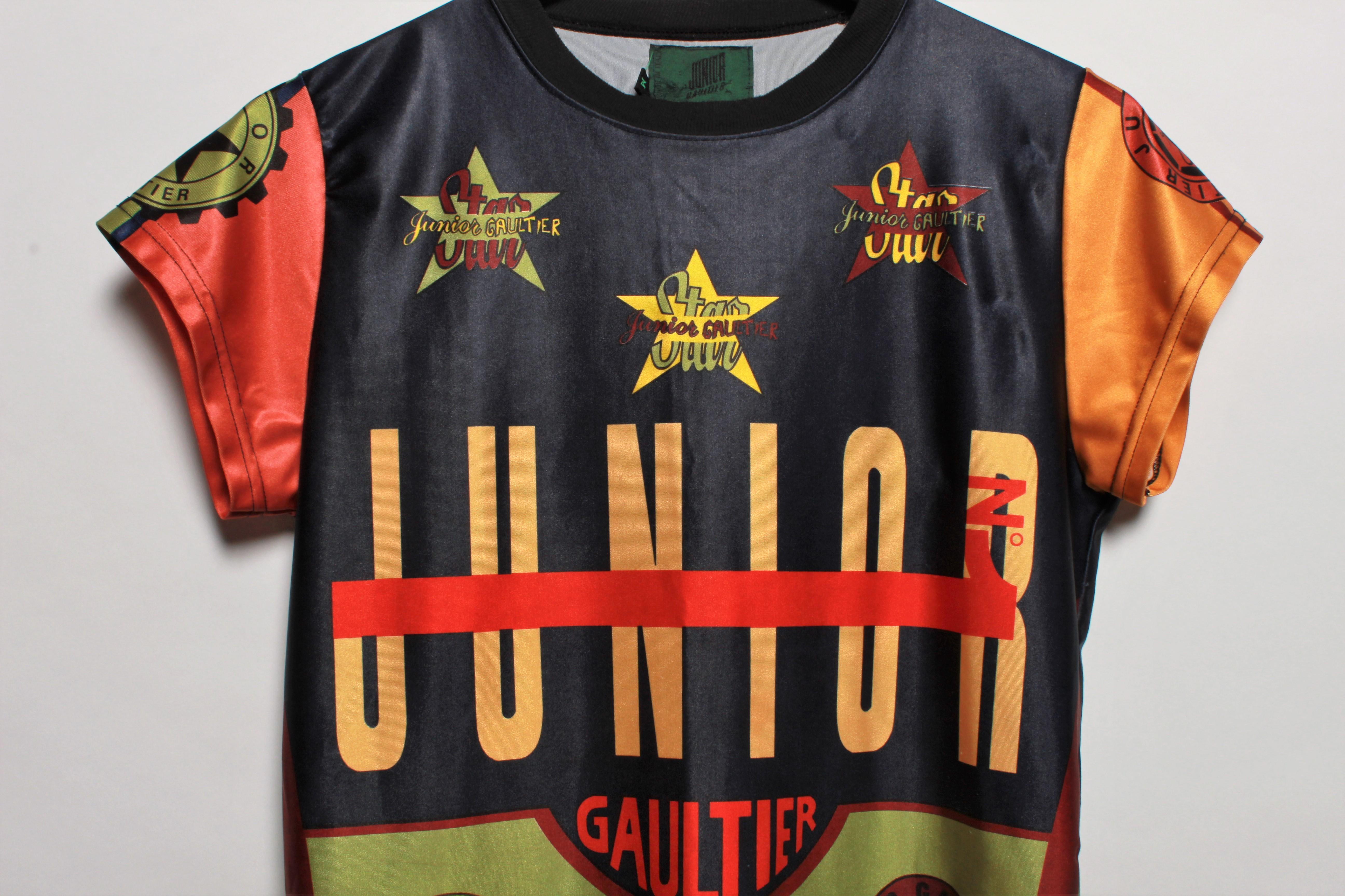 JEAN PAUL GAULTIER vintage iconic multicolored T-shirt.

This T-shirt features multicolored graphic blocks with iconic JPG print.
 Ribbed textured round neck, short sleeves, stretch shiny jersey.

Label reads JUNIOR GAULTIER.
Made in Italy.

Size