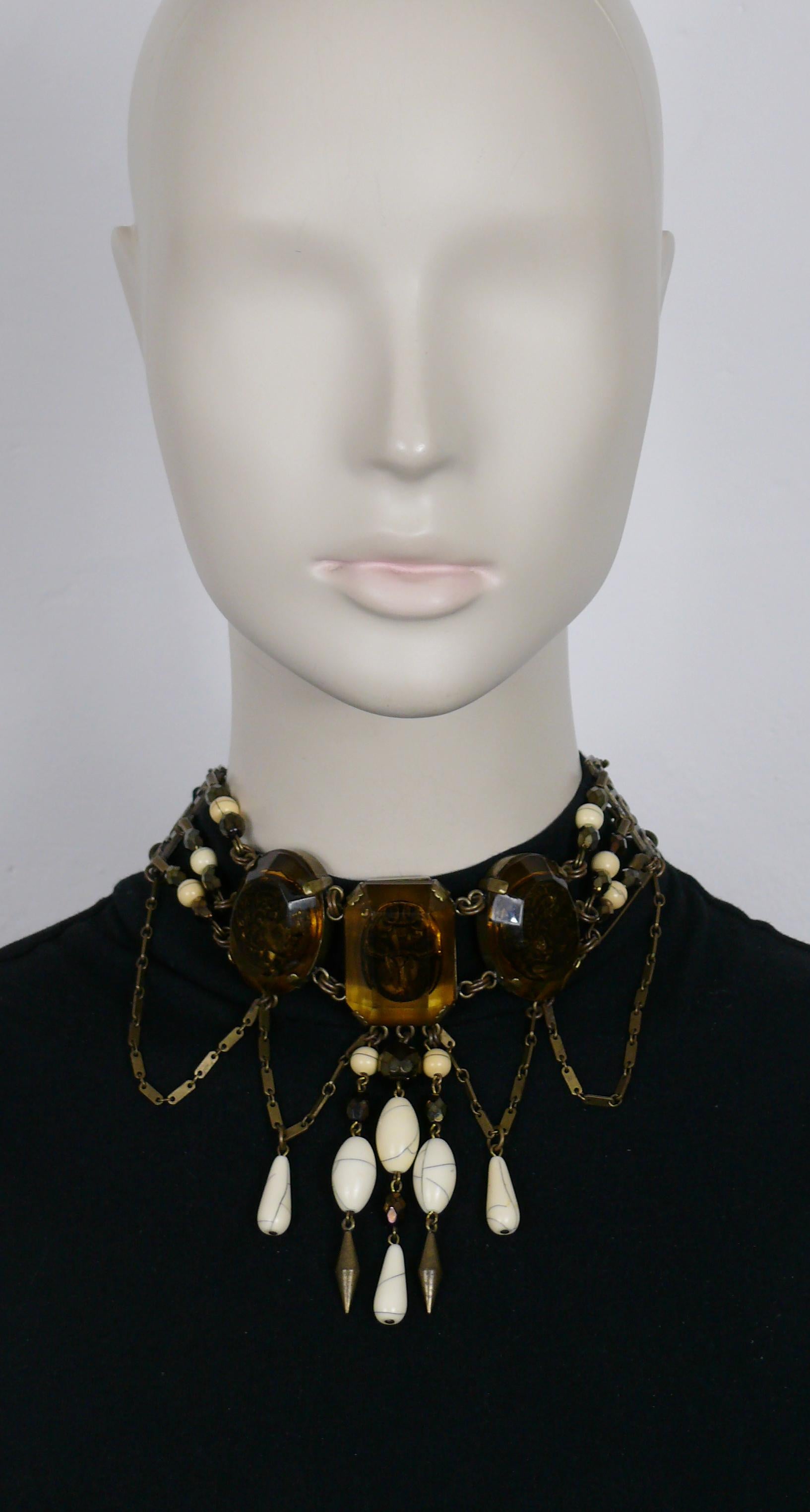 JEAN PAUL GAULTIER vintage antiqued bronze tone choker necklace featuring 3 amber color resin cameos links featuring inlaids with scarab and ancient roman cameo profiles, safety pins, facetted bronze color glass beads, cracked off-white beads, metal