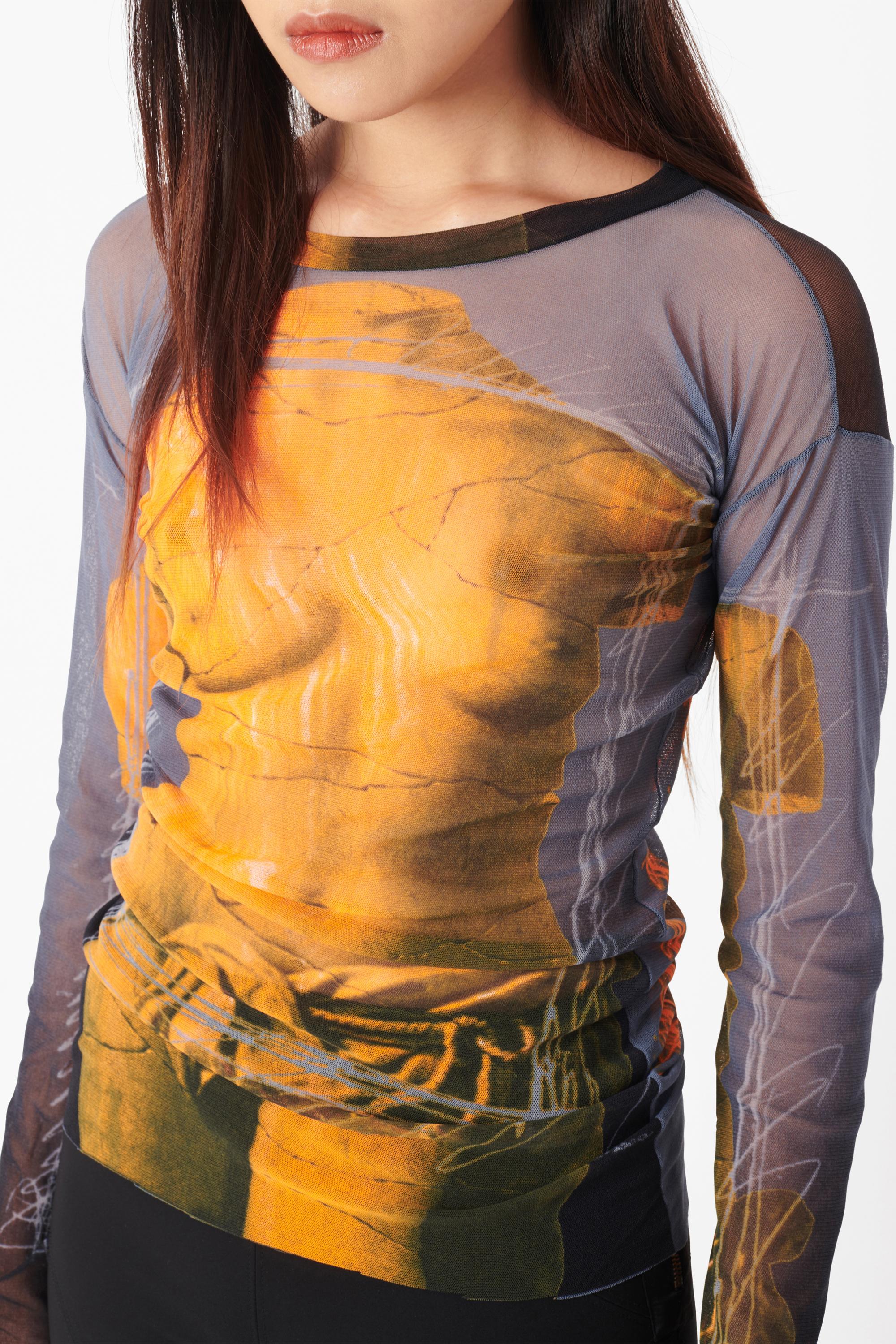 Vintage Jean Paul Gaultier Spring Summer 1999 mesh top. Features the iconic Soleil Venus De Milo print in orange and blue, long sleeves, high scoop neck in high stretch. In excellent vintage condition.

Brand: Jean Paul Gaultier
Color: Blue
Size: UK