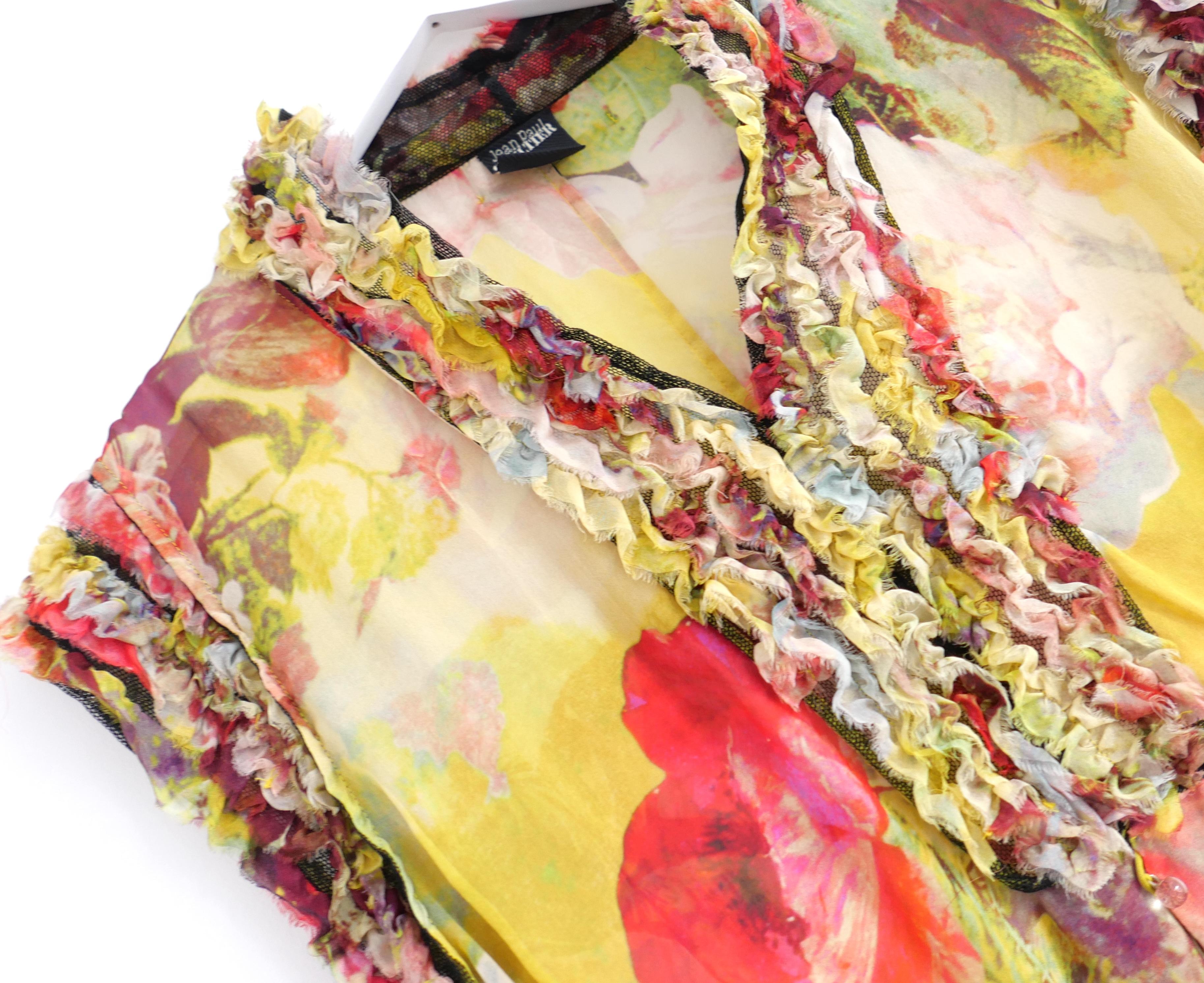 Iconic vintage Jean Paul Gaultier blouse from the Spring 2006 collection. Made from super soft rose print silk with gorgeous it has hand cut frill detailing. It has a semi tailored fit with pink glass sphere buttons. Size IT36/FR42/UK14. Approximate