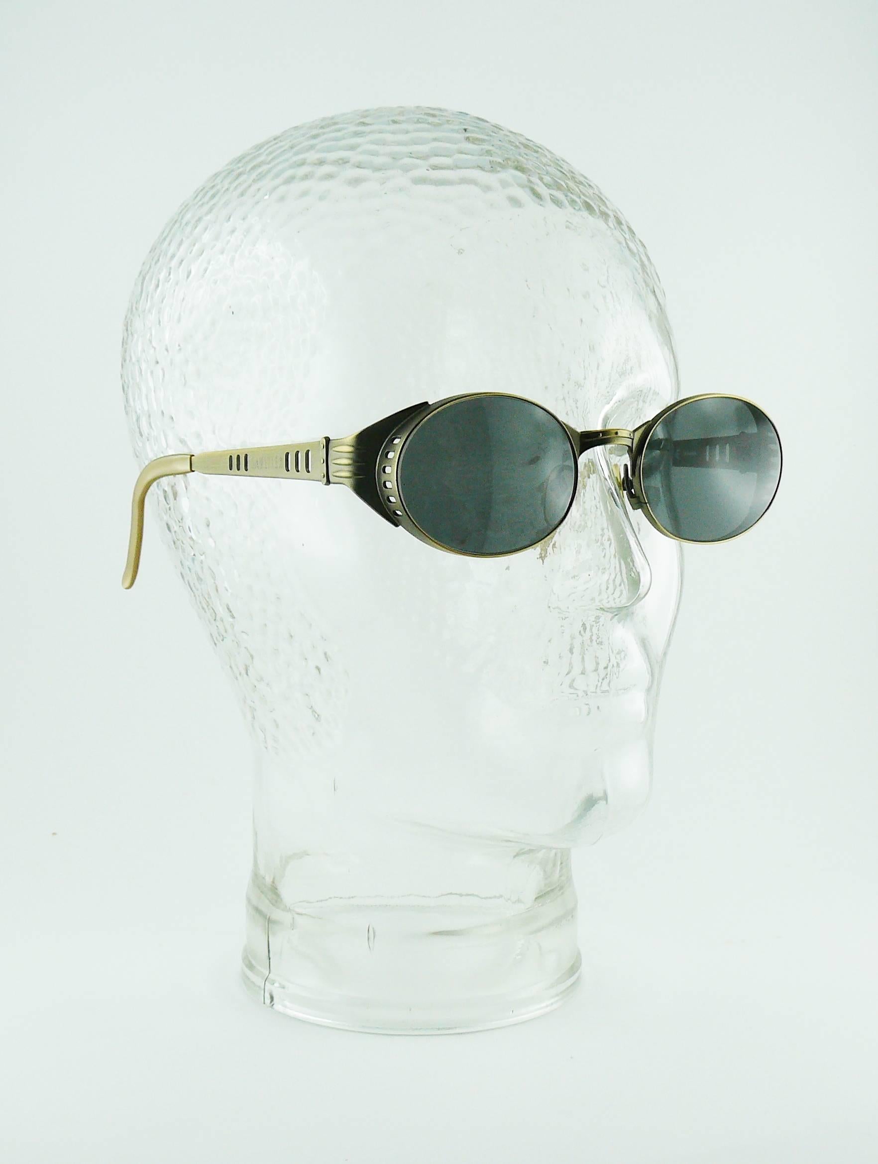 JEAN PAUL GAULTIER vintage steampunk sunglasses.

Bronze toned frames embossed GAULTIER.
Tinted lenses.

Marked JEAN PAUL GAULTIER.
56-6102.
Made in Japan.

Indicative measurements : max. width approx. 13.5 cm (5.31 inches) / width between lenses