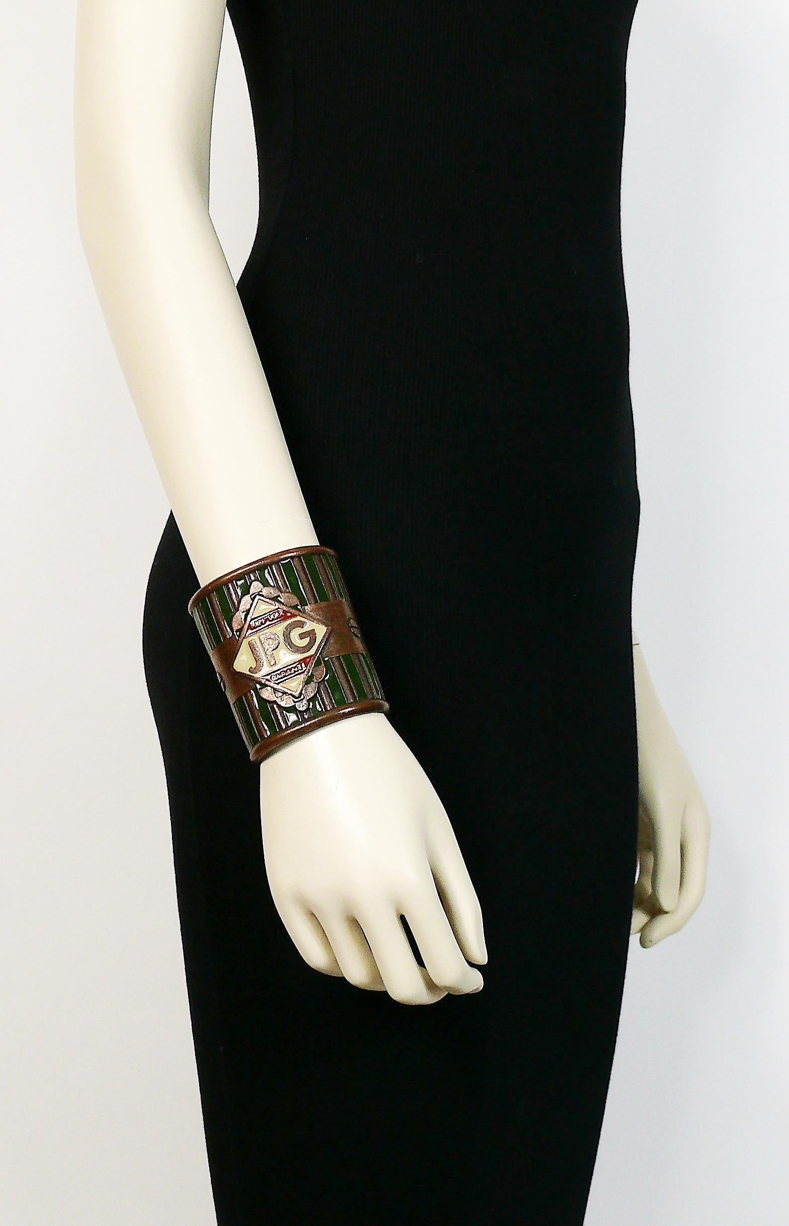 JEAN PAUL GAULTIER antiqued copper tone wide cuff bracelet featuring multicolor enamel embellishement, rivets and JPG monogram on front.

Indicative measurements : inner max. width approx. 6.2 cm (2.44 inches) / inner min. width approx. 5.5 cm (2.17