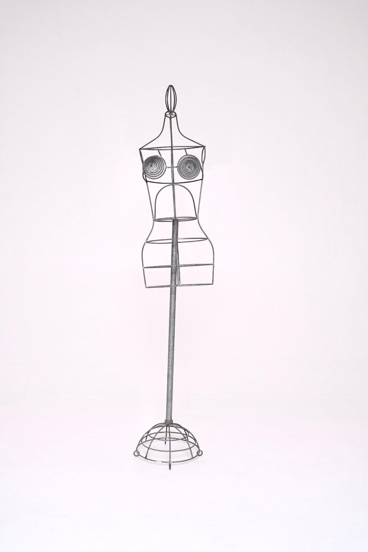 An iconic and collectible wirework dress form mannequin by legendary French designer Jean Paul Gaultier, created in the 1990s. This sculptural piece exemplifies Gaultier’s bold, avant-garde aesthetic and is a direct reference to his famed cone bra