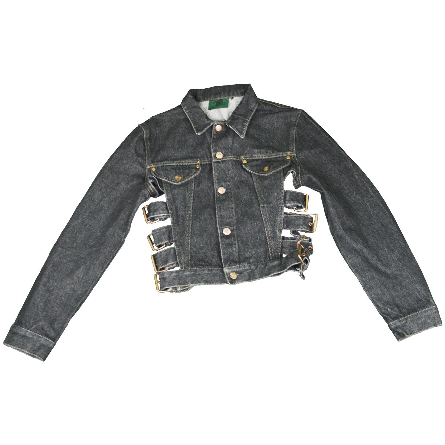 An amazing vintage women's cropped denim / jeans jacket from the late 80s / early 90s by iconic French fashion designer, Jean Paul Gaultier. In a dark grey denim with bondage inspired buckle straps at the side which nips in the waist and gives a