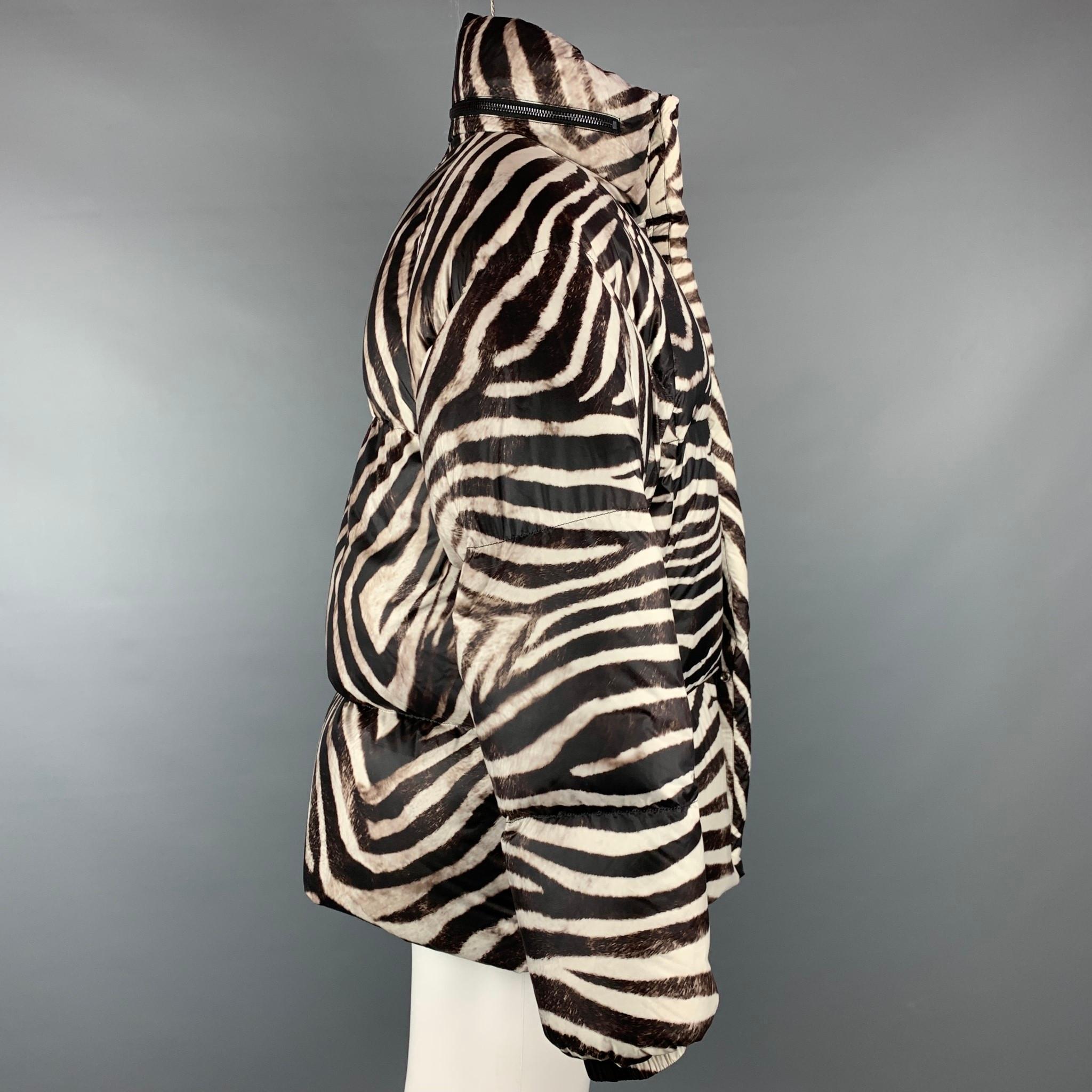 JEAN PAUL GAULTIER x BOSIDENG jacket comes in a brown & white zebra print nylon with goose down filled featuring a puffer style, hooded, slit pockets, sleeve patch detail, and a zip & snap button closure.

Excellent Pre-Owned Condition.
Marked: