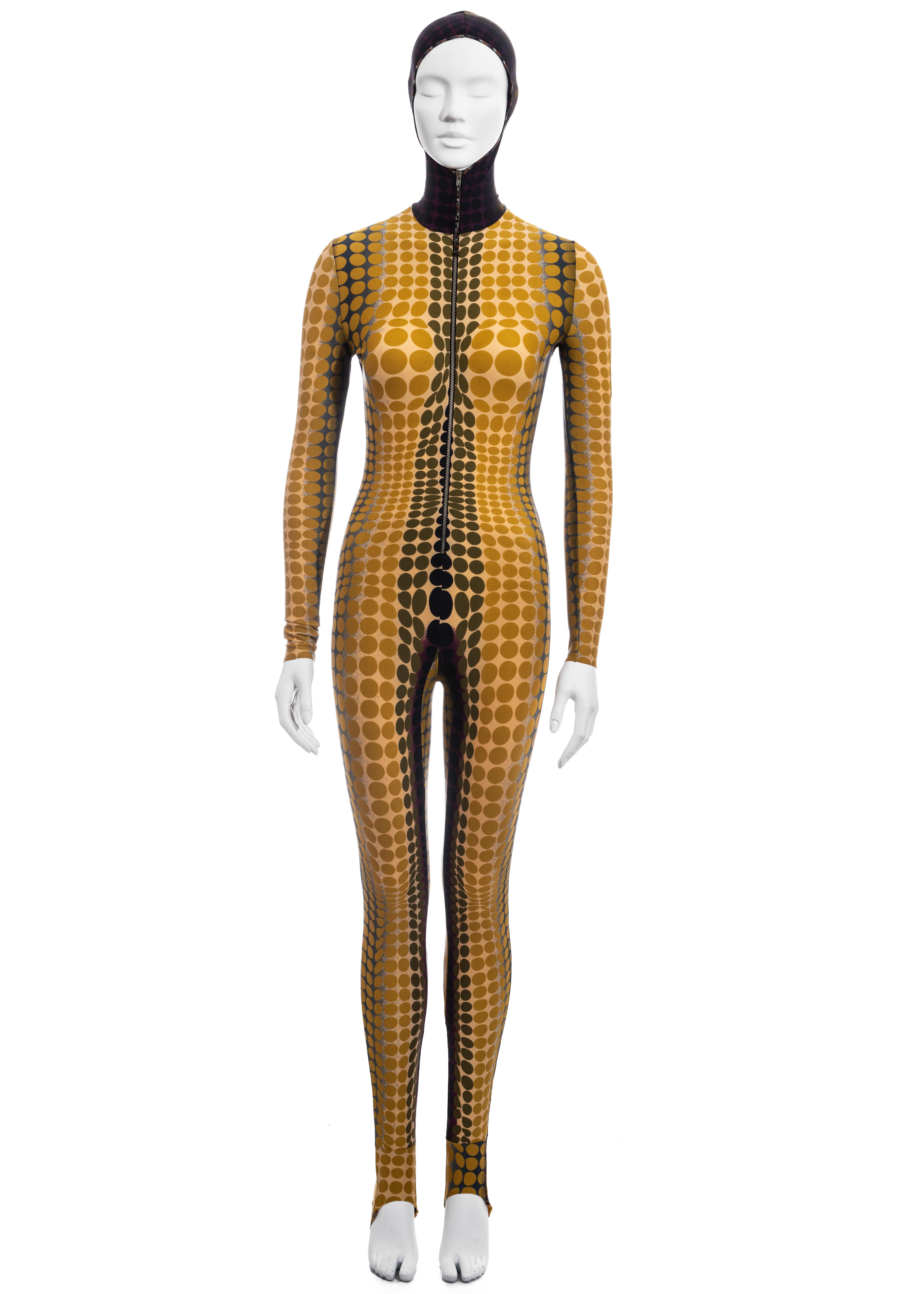 ▪ Jean Paul Gaultier yellow cyber dot catsuit 
▪ 78% Nylon, 22% Spandex
▪ Victor Vasarely inspired print 
▪ Fitted hood
▪ Front zip fastening 
▪ Size Medium
▪ Fall-Winter 1995 