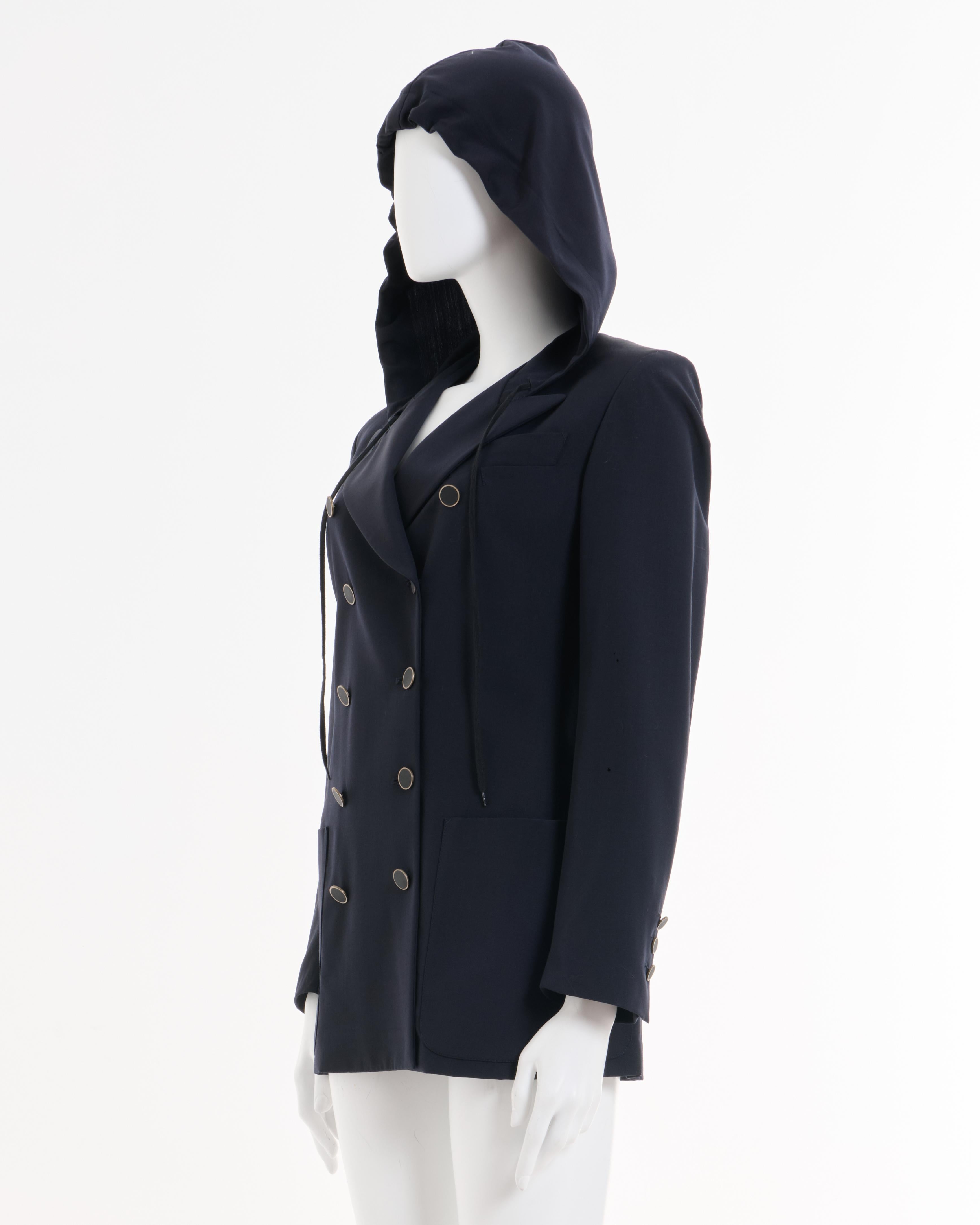 - Jean Paul Gaultier Blazer azul con capucha y doble botonadura
- Primavera-Verano 1990 'Rhapsody in Blue
- Cierre frontal con botones 
- Tres bolsillos 
- Con capucha a partir de las solapas con cordón ajustable 
- Medio forrado 
- Hombros