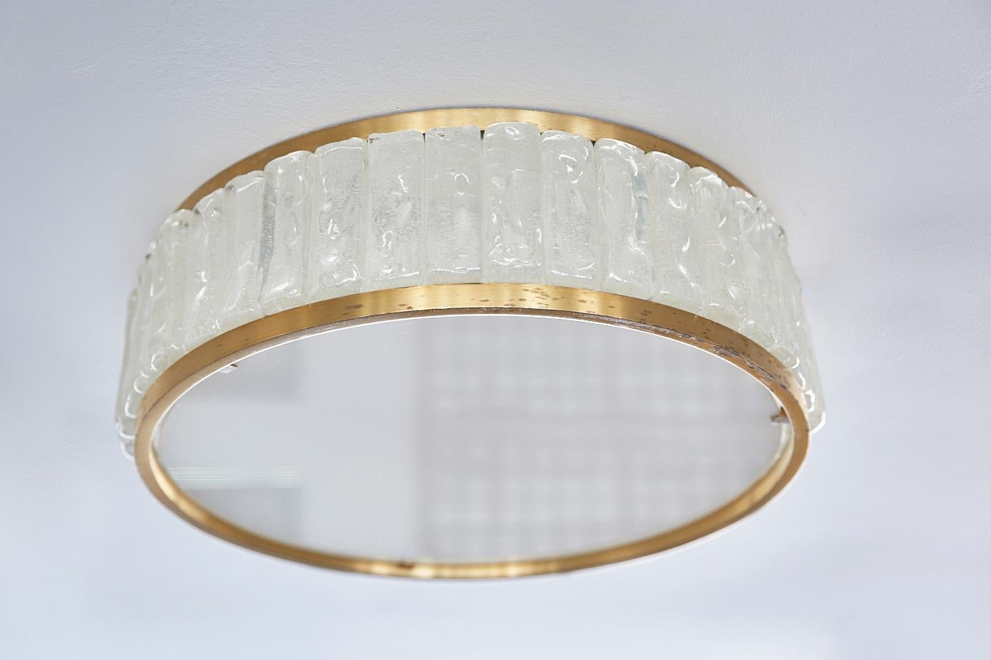 Stunning circular flush mount by Jean Perzel. Beautifully constructed light made up of solid brass trim, thick solid individual side glass pieces and an opaque glass diffuser. Nice patina and age to brass. 
Two smaller flush mounts also available