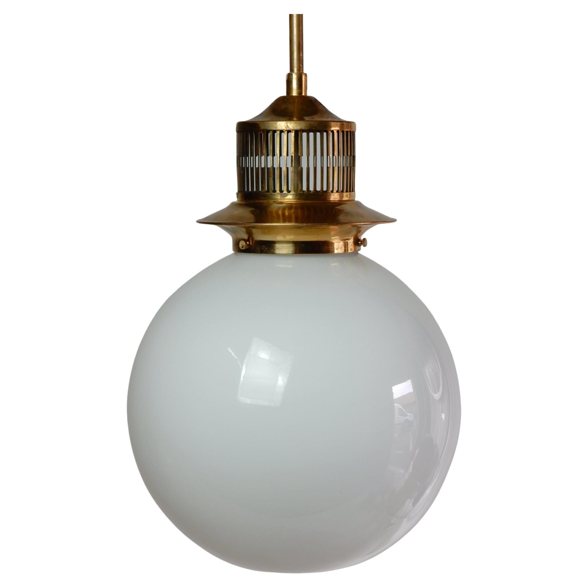 1960s brass and milk glass ball pendant lamp. Not signed by designer or manufacture.
Commercial size pendant, perfect for kitchen islands/bars etc.
Drops 33in from ceiling. Glass ball is 12in wide. 4