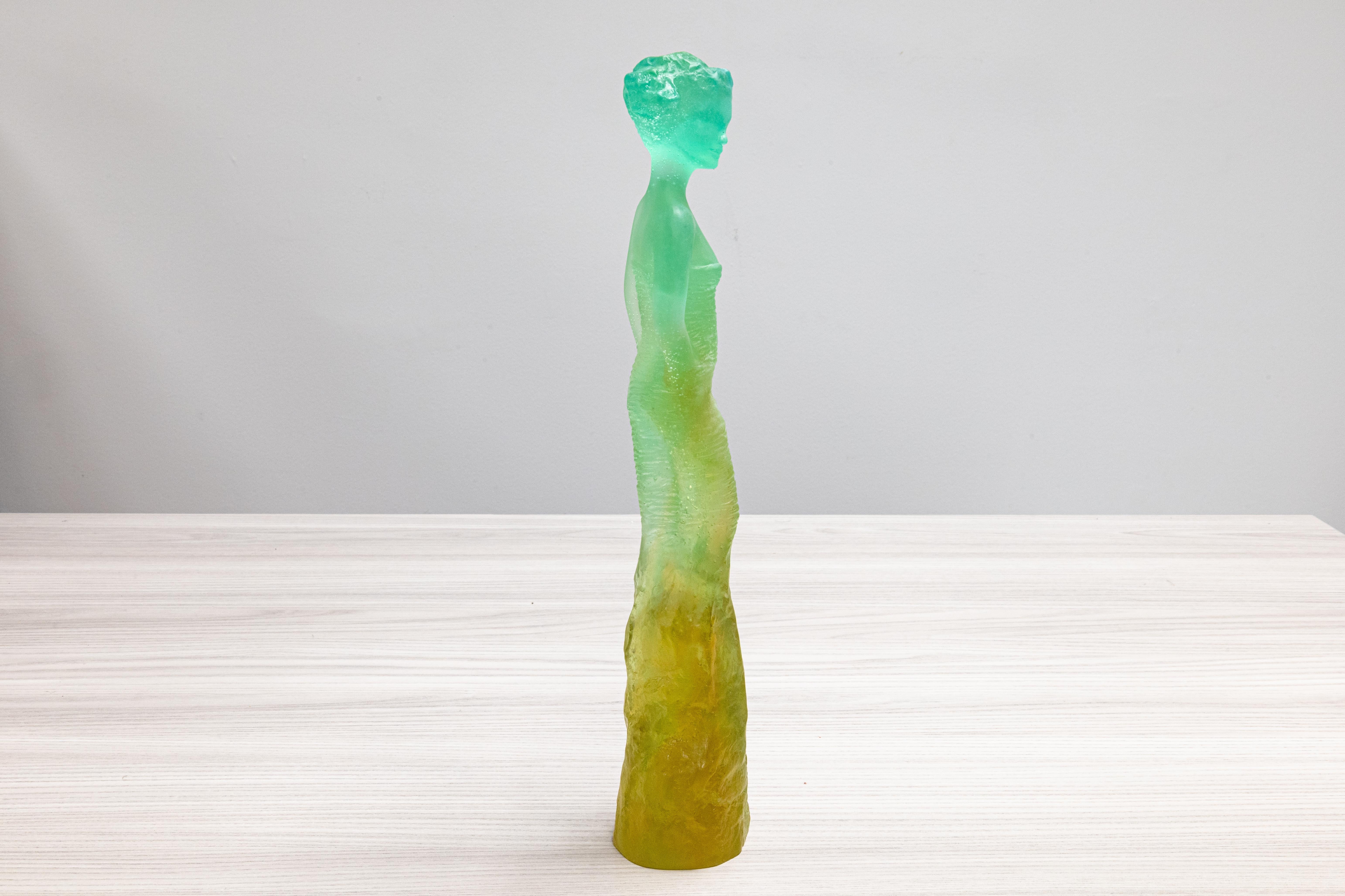An elegant and vibrant figurative glass sculpture with a unique ombre effect of aqua to green to a golden color titled “Eléonore” designed by Jean-Philippe Richard for the studio of Daum France. Etched signature on bottom from Daum and Jean-Philippe