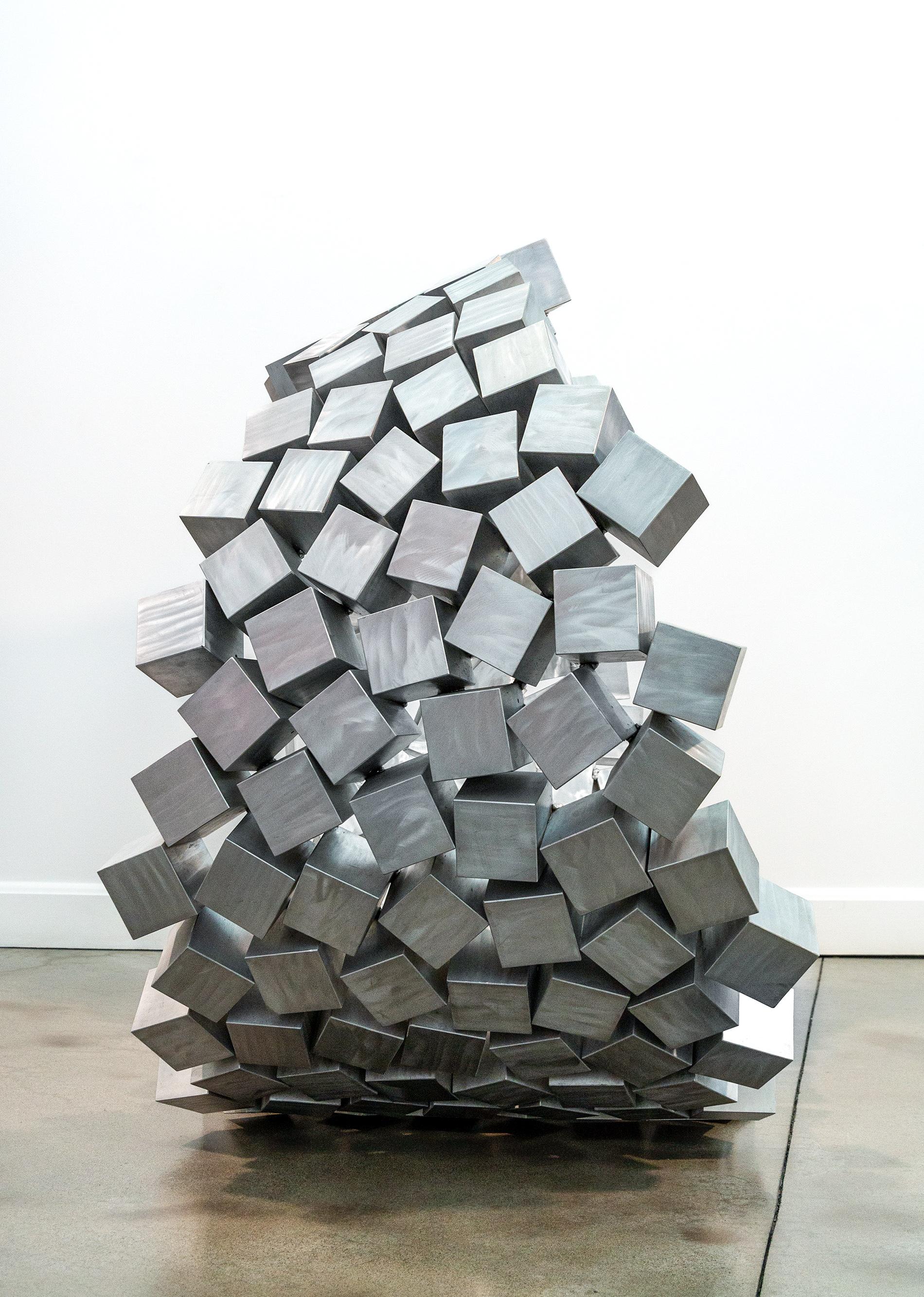 He has been called the ‘Light Sculptor.’ Quebec artist Jean-Pierre Morin is inspired by the light and shapes found in nature. The pleasing organic shape of this gorgeous sculpture is accentuated by the choice of material—highly polished cubes of