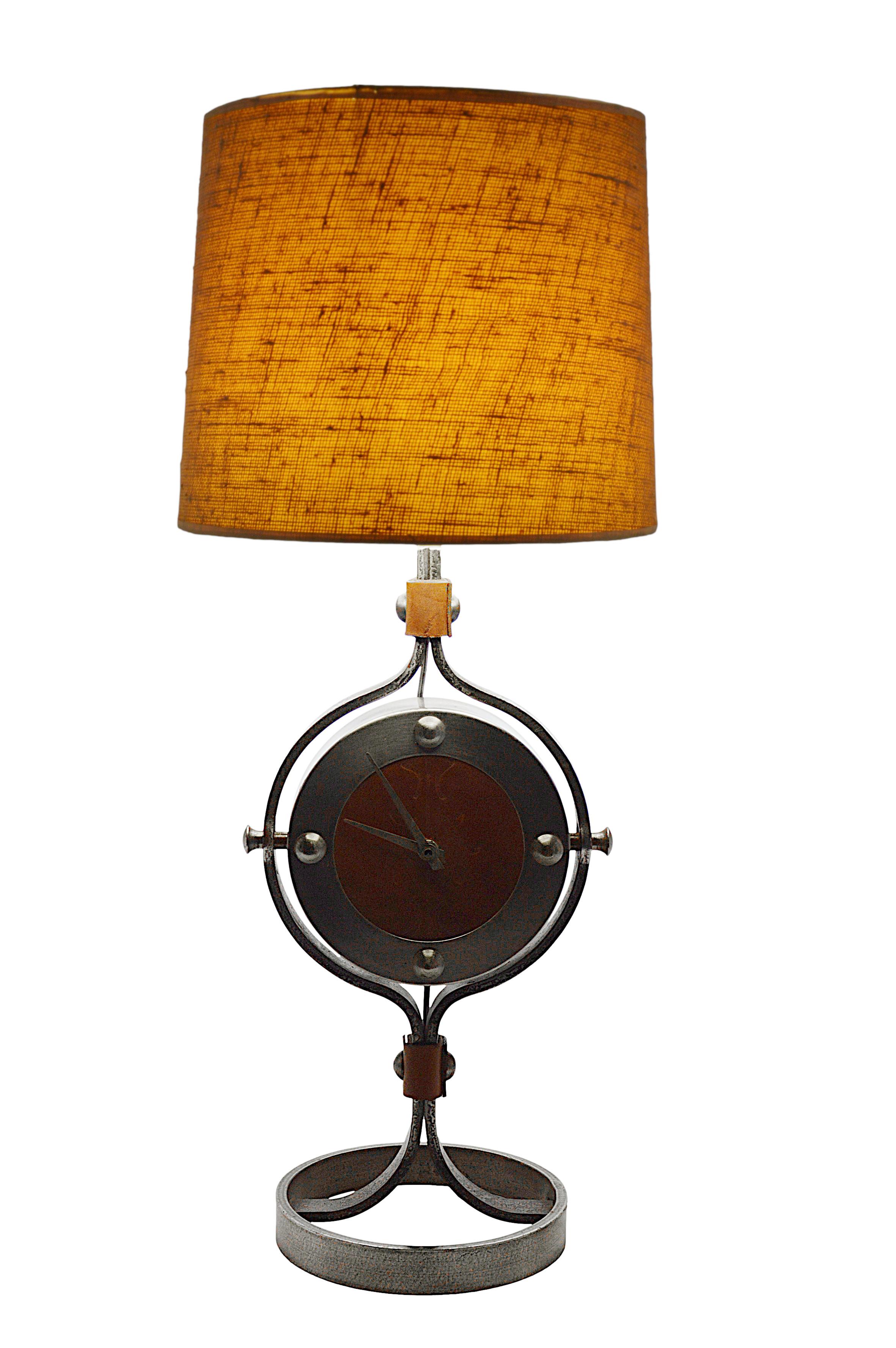 Large clock lamp by Jean-Pierre Ryckaert, Paris, circa 1950. Wrought-iron and leather. Decorated leather dial. Measurements without shade - height with socket : 21