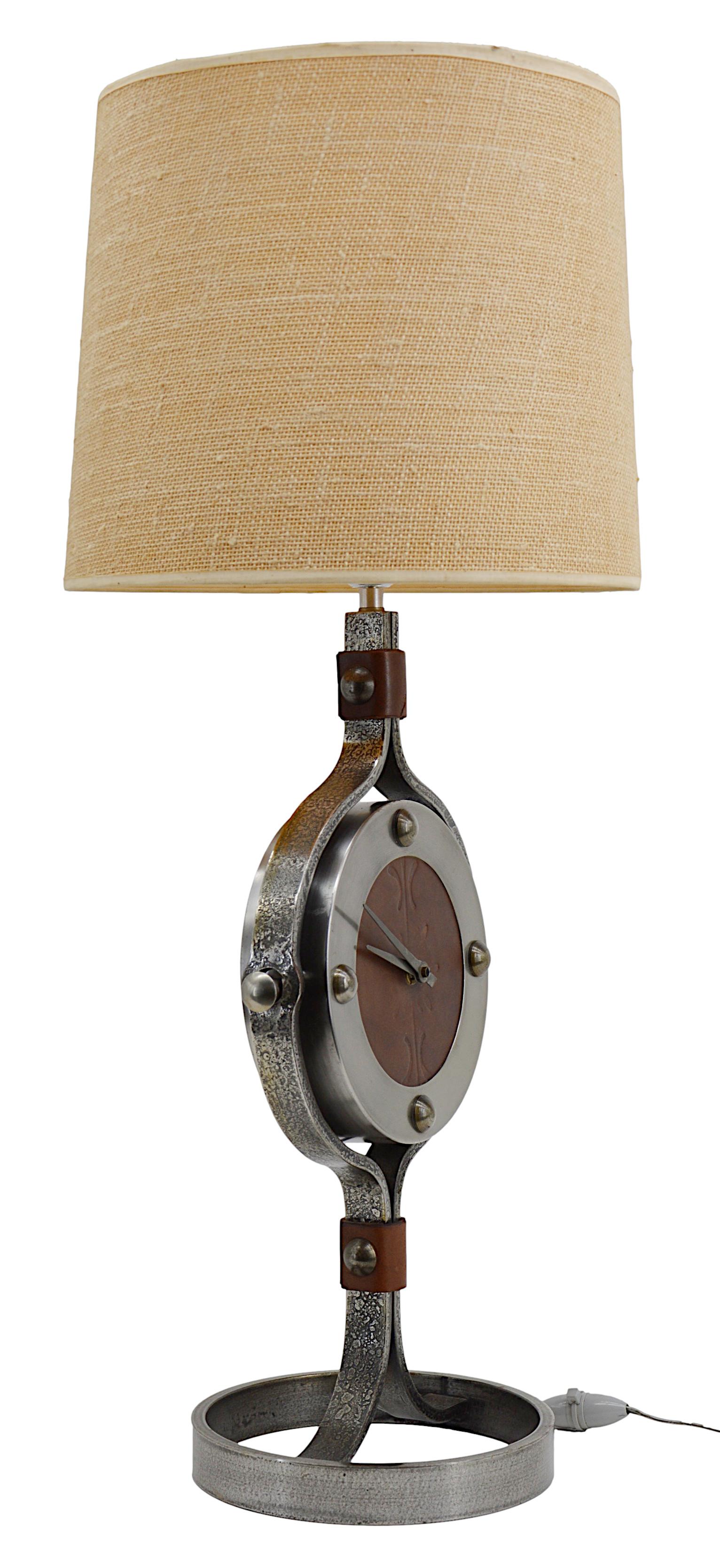 Large clock lamp by Jean-Pierre Ryckaert, Paris, circa 1950. Wrought-iron and leather. Decorated leather dial. Measurements without shade - height with socket : 21