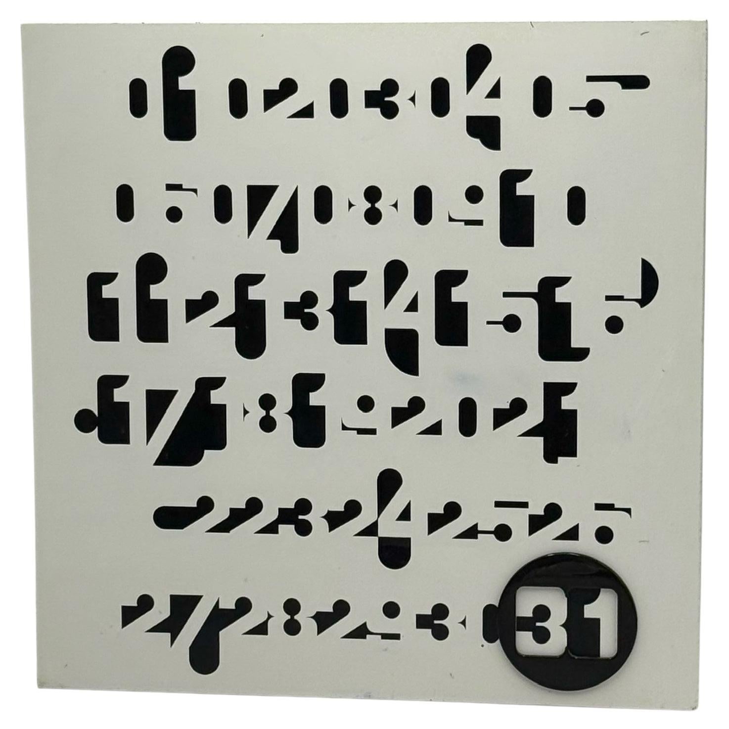 This rare “Imbroglio” perpetual wall calendar was designed in the 1970s by Jean Pierre Vitrac and produced by Piranha in France. A standout example of French modernist design, the calendar features a white perforated metal front with bold, stylized