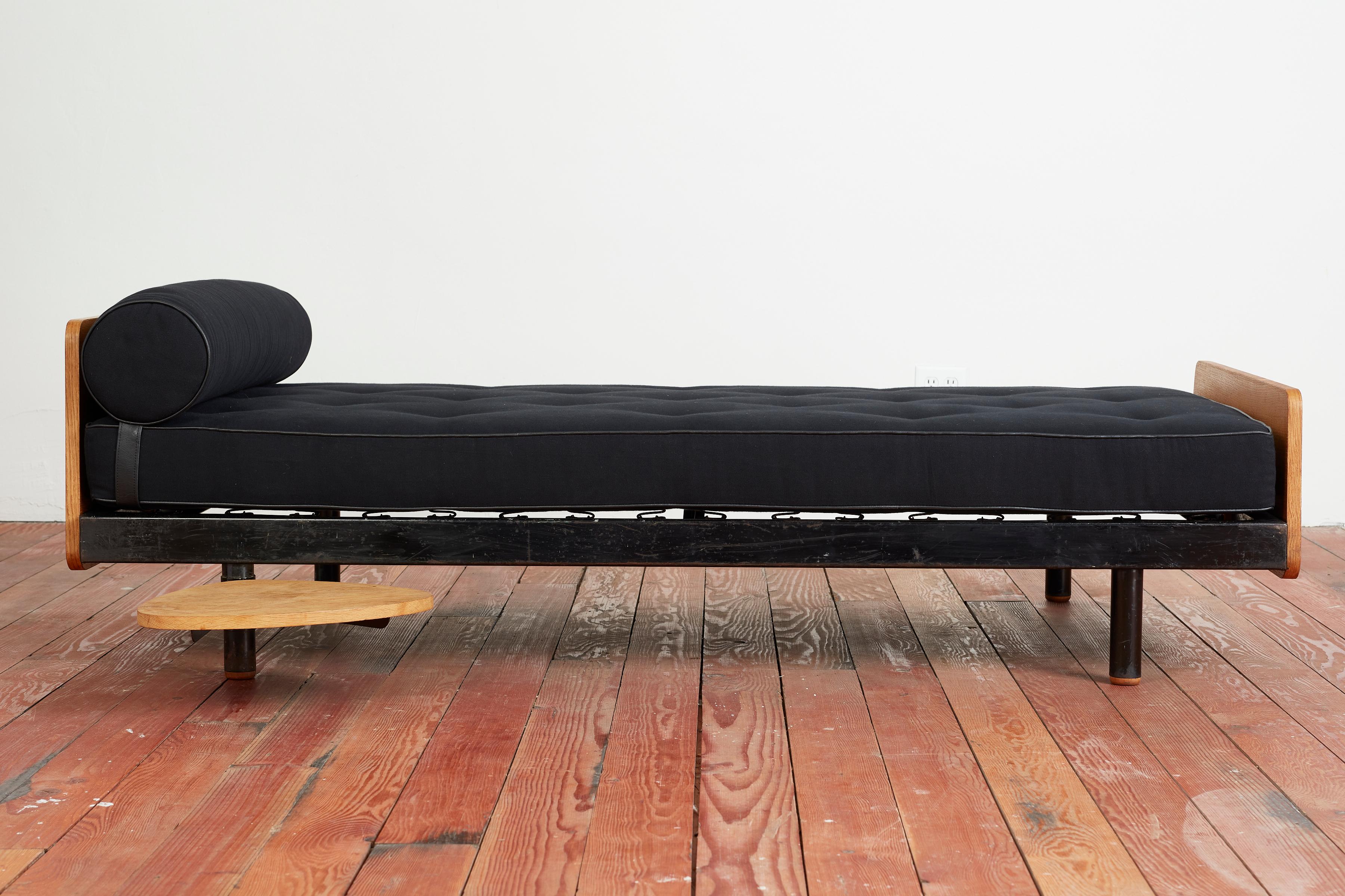 Original S.C.A.L. daybed designed by Jean Prouvé - France, 1954
Enameled steel frame, linen upholstery with original wood headboard and footboard. 
Daybed features signature swivel side table designed by Charlotte Perriand.
Good condition, with