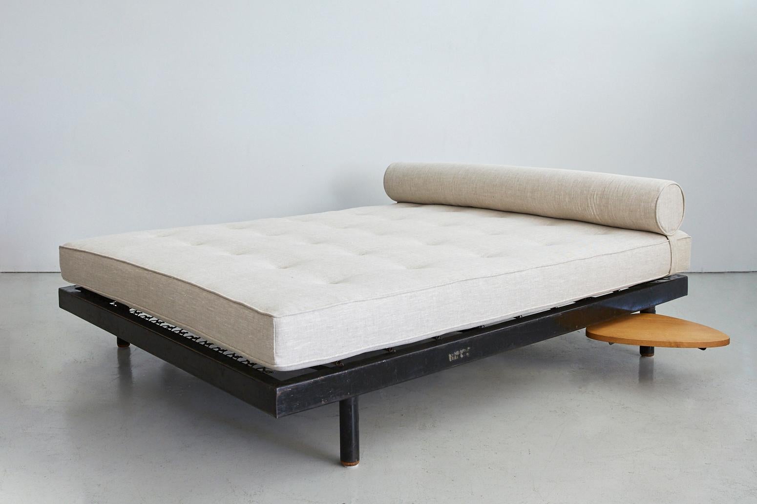 Rare and stunning S.C.A.L. Antony double daybed with pivoting oak side tables designed by Jean Prouvé and Charlotte Perriand. Newly upholstered in slubby greige linen. Manufactured by Ateliers Prouvé, France, circa 1951.