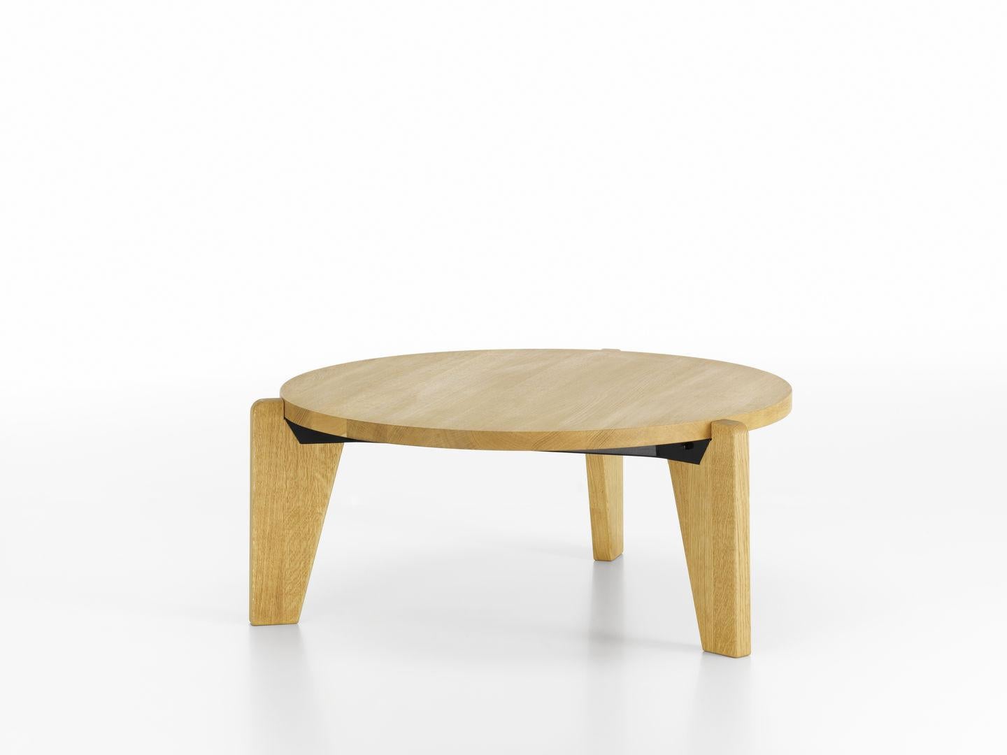 Coffee table designed by Jean Prouvé in 1944.
Manufactured by Vitra, Switzerland.

In the early 1940s, Jean Prouvé began to work more extensively with wood. The Guéridon Bas table has a heavy top in solid oak or American walnut resting on three