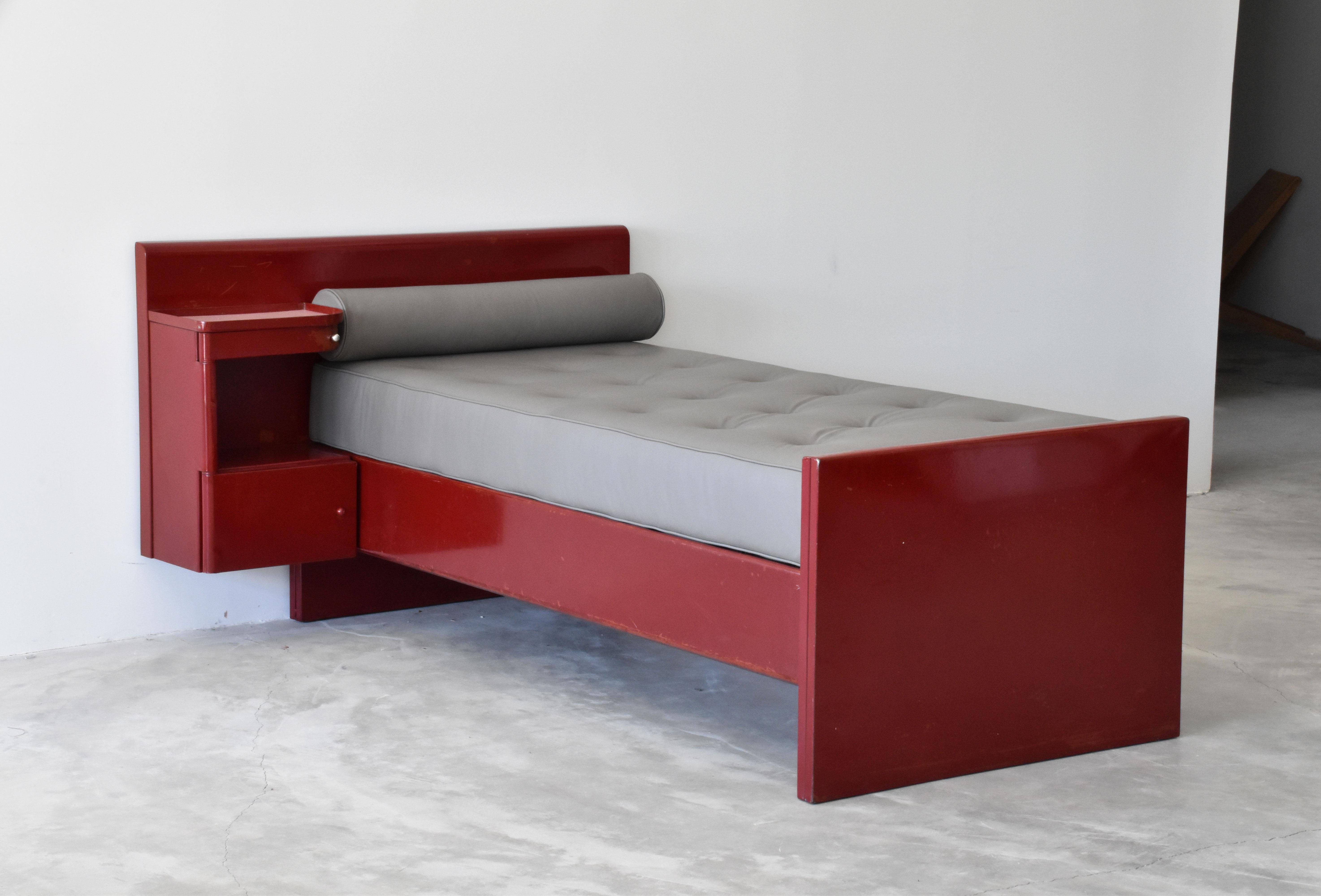 An early functionalist daybed designed by Jean Prouvé & Jules Leleu, from their iconic commission for Sanatorium Martel de Janville, Plateau d'Assy, France. The daybed features a built-in side cabinet. 

Secondary cushions upholstered in dyed in