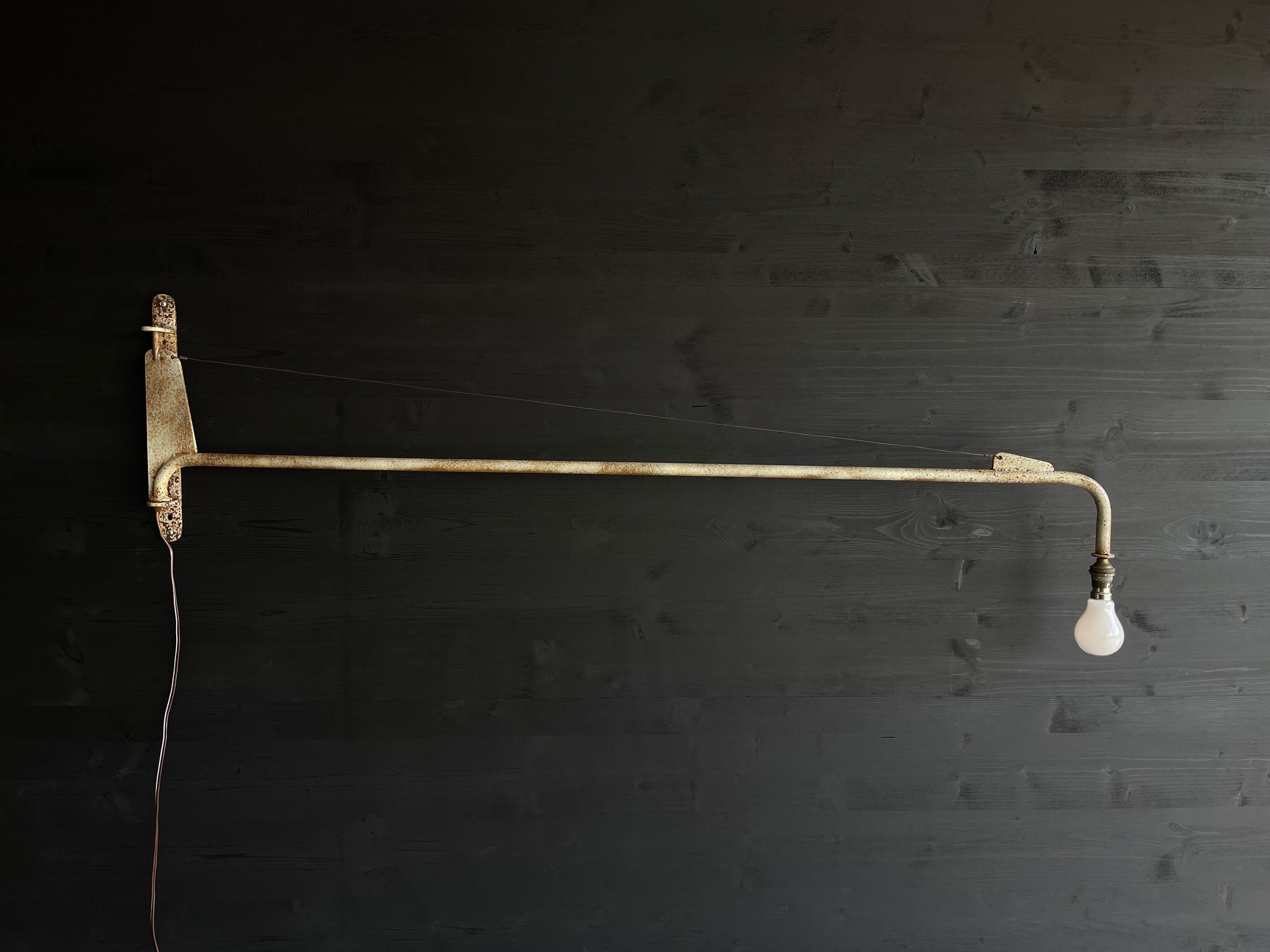 Jean Prouvé, model Sconce, «Petite potence» wall lamp, designed 1947, manufactured in france.
Steel arm with wire reinforcement, natural oxidation of time. B22 Bulb.

Jean Prouvé believed in design as a vehicle for improvement. His manufactory