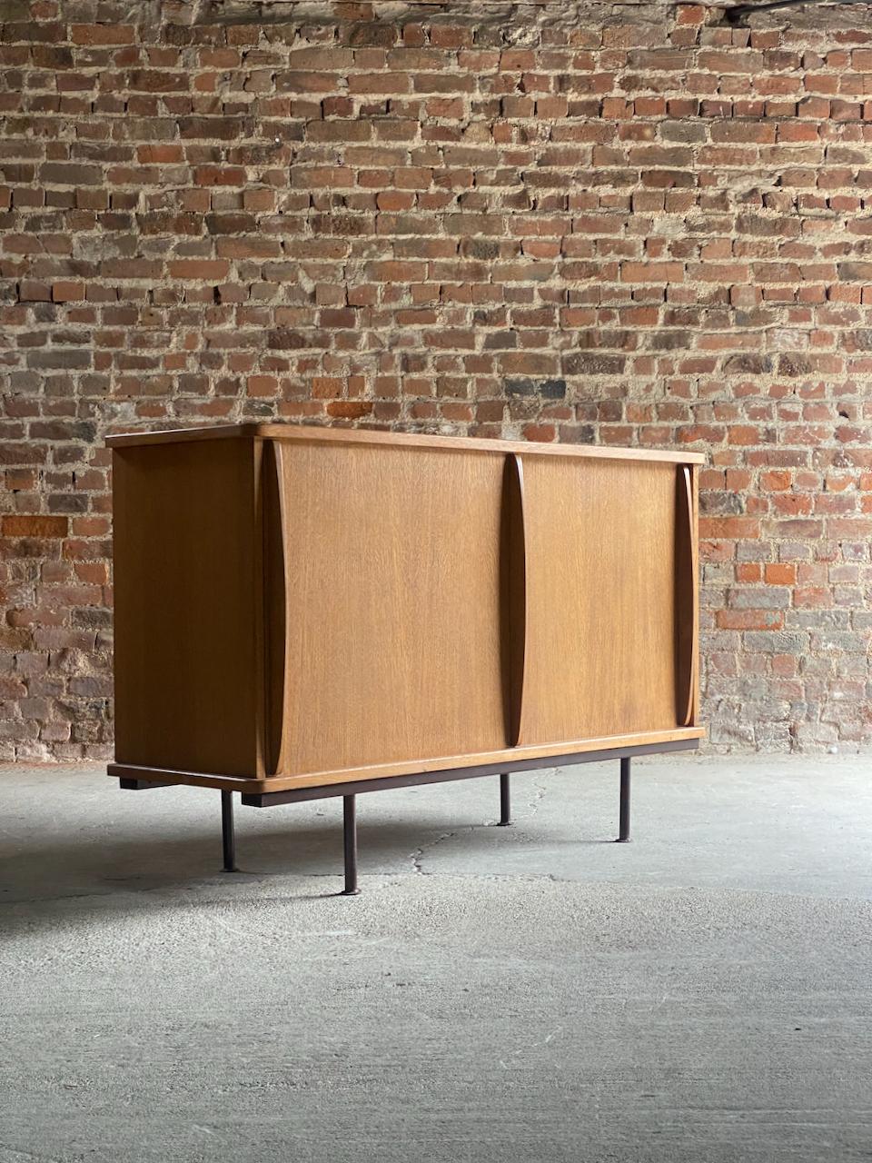 Jean Prouve oak sideboard cabinet by Ateliers France circa 1940

Jean Prouvé Oak Sideboard produced by Ateliers Jean Prouvé, Nancy, France circa 1940, the solid oak top over a quadrangular body with two sliding doors with vertical interior grips