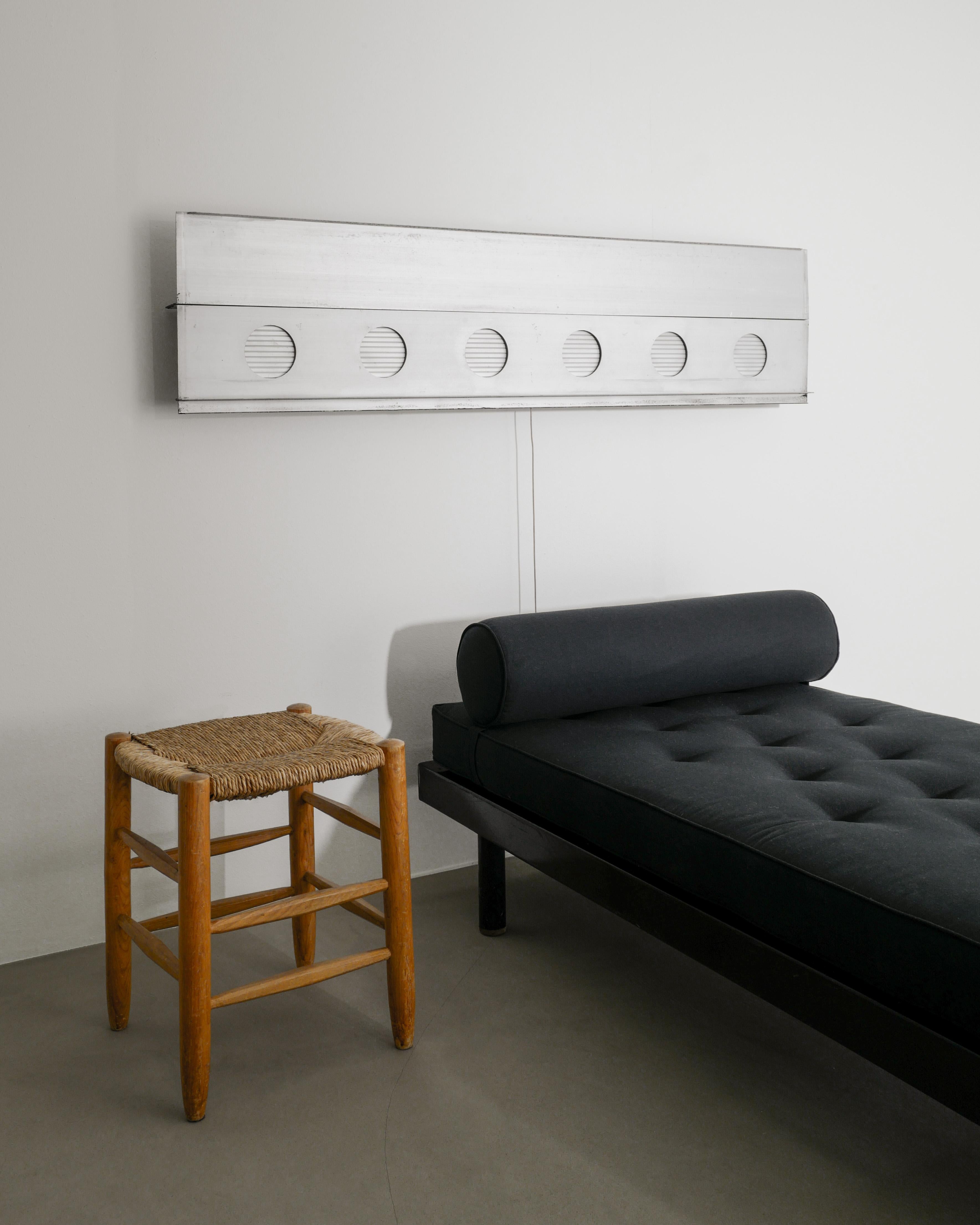 Rare French set of mid century iconic and important design pieces by Jean Prouvé & Charlotte Perriand. This set features an all original architectural wall mounted areator air aluminum ventilation panel for C.I.M.T and a S.C.A.L 450 black daybed