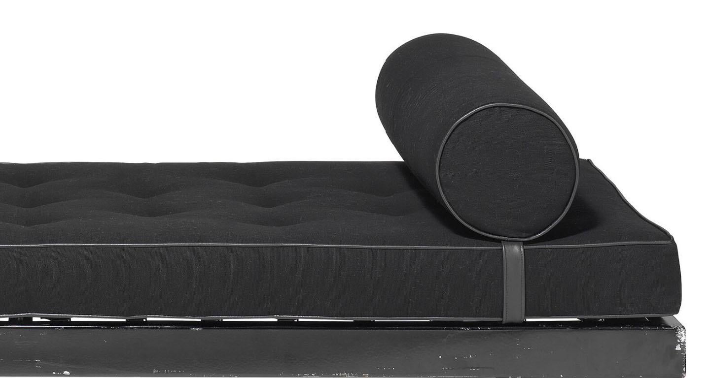 Jean Prouve SCAL daybed in black lacquered metal daybed with oak shoes. Mattress upholstered in black cotton canvas with leather piping and buttons. Model 450. Made early 1950s by Les Ateliers Jean Prouvé, France. 
Provenance: Galerie Downtown