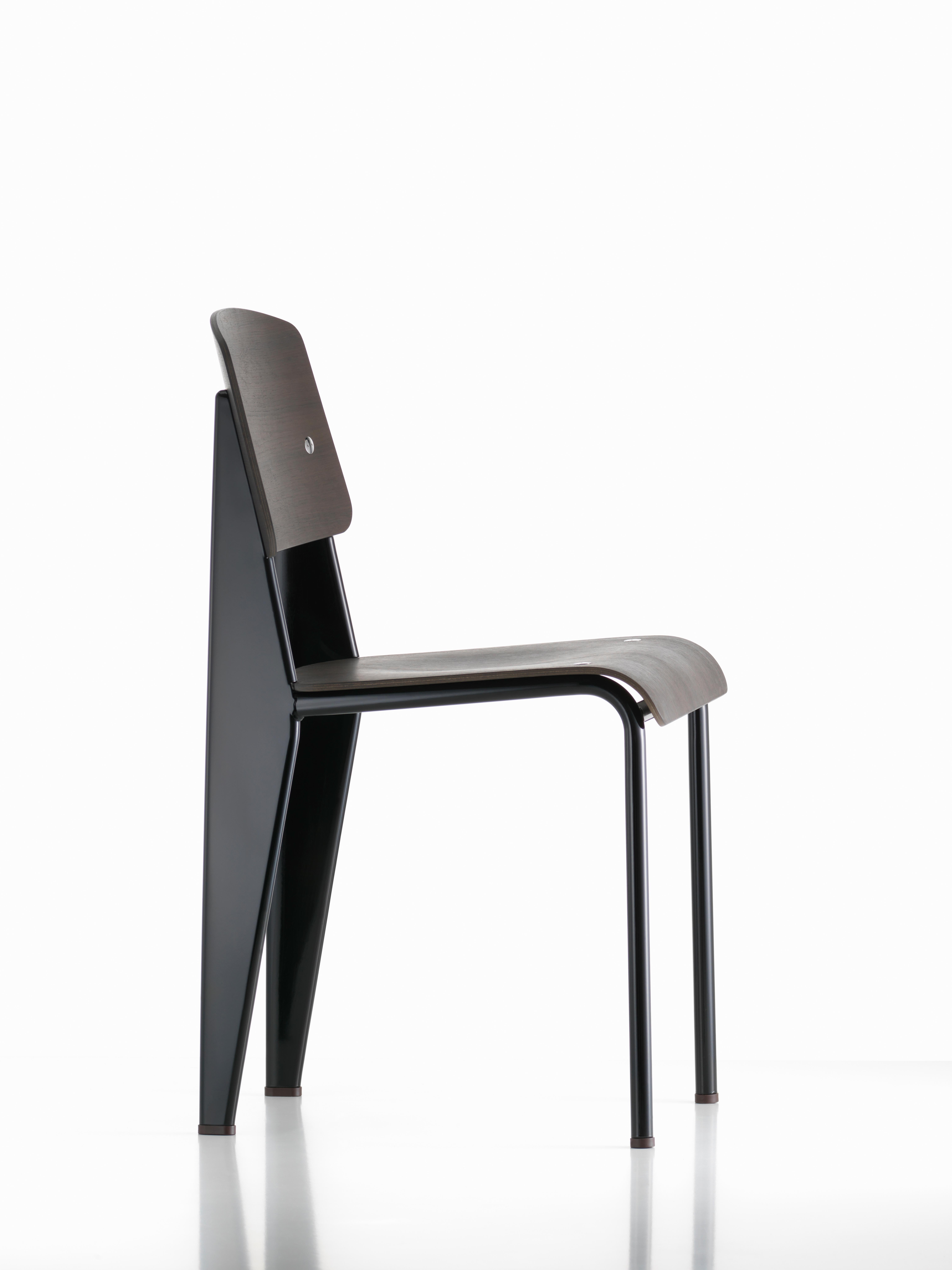 Jean Prouvé standard chair in black tinted walnut and black metal for Vitra. The standard chair is an early masterpiece by the French designer and engineer Jean Prouvé. Originally designed in 1934, the Standard evolved into one of the most famous