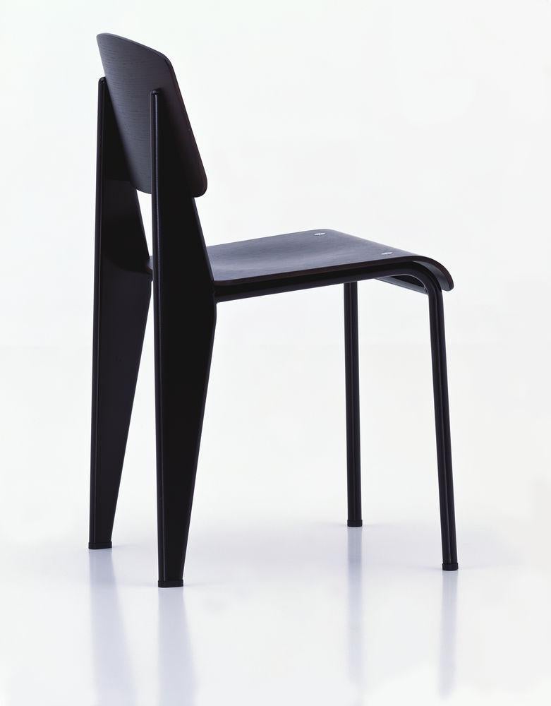 Jean Prouvé Standard chair in dark oak and black metal for Vitra. The Standard chair is an early masterpiece by the French designer and engineer Jean Prouvé. Originally designed in 1934, the Standard evolved into one of the most famous classics of