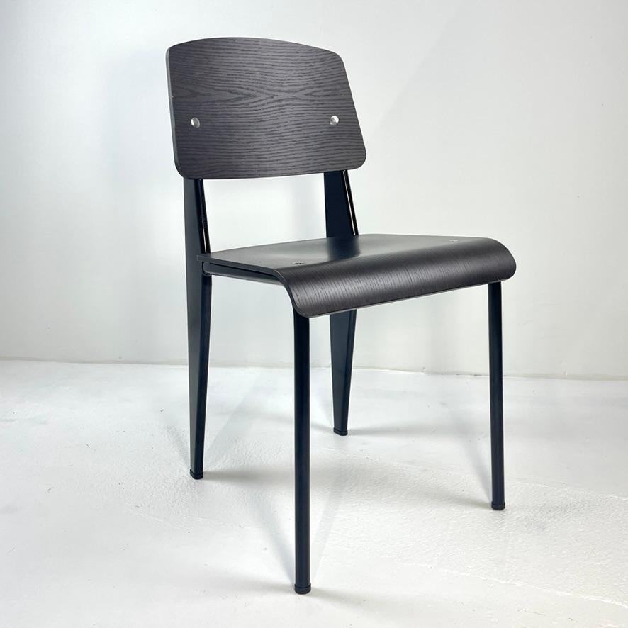 Like new Vitra standard chair in Dark Oak/ deep black.
 Jean Prouvé always strove for the most efficient designs, evident in classics such as his Standard Chair (1934). This piece, which comprises a utilitarian yet visually arresting combination of
