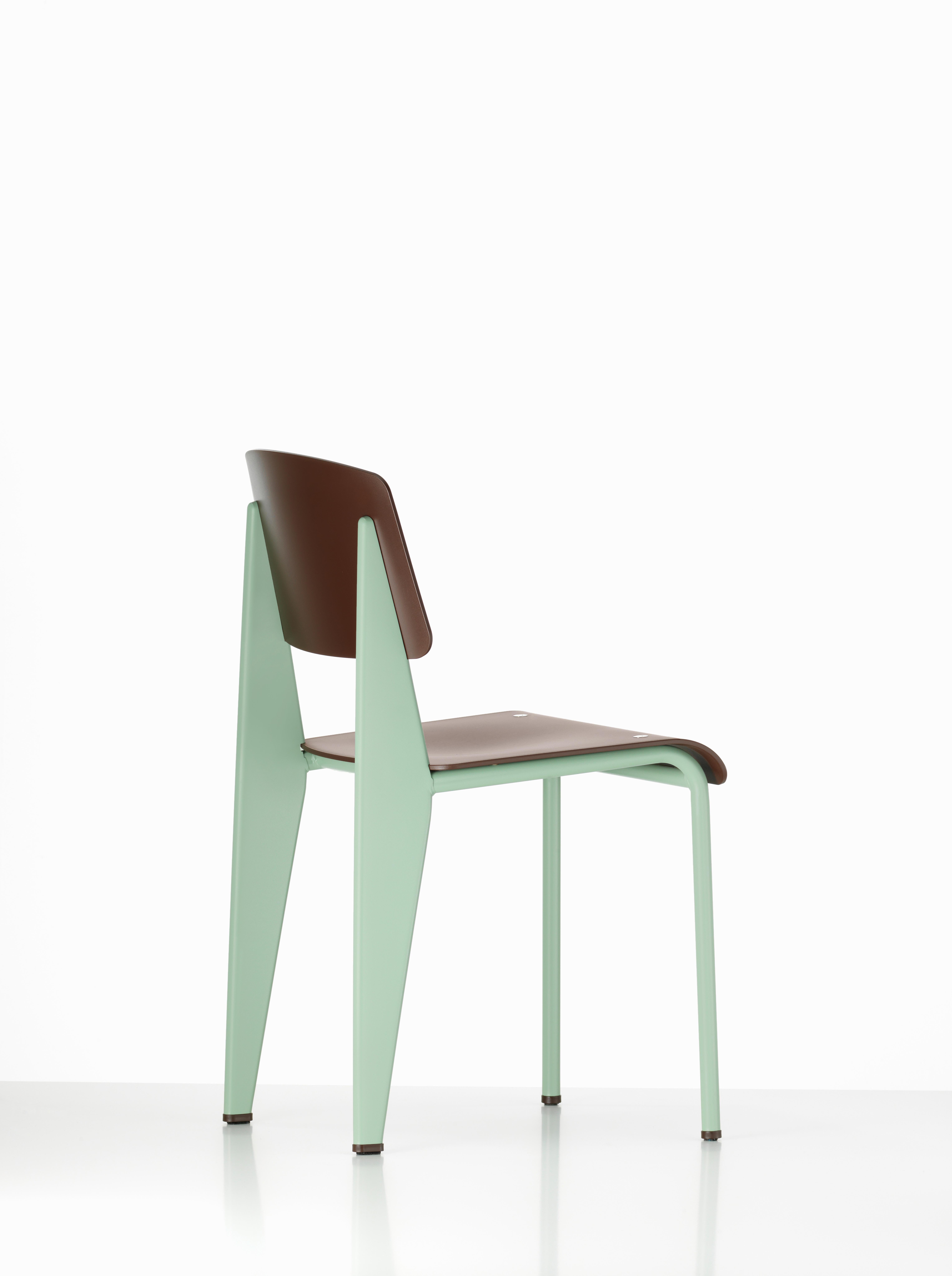 Jean Prouvé standard chair SP in Teak brown and mint metal for Vitra. The standard SP chair is a modernized variation on an early masterpiece by the French designer and engineer Jean Prouvé. Originally designed in 1934, the Standard evolved into one