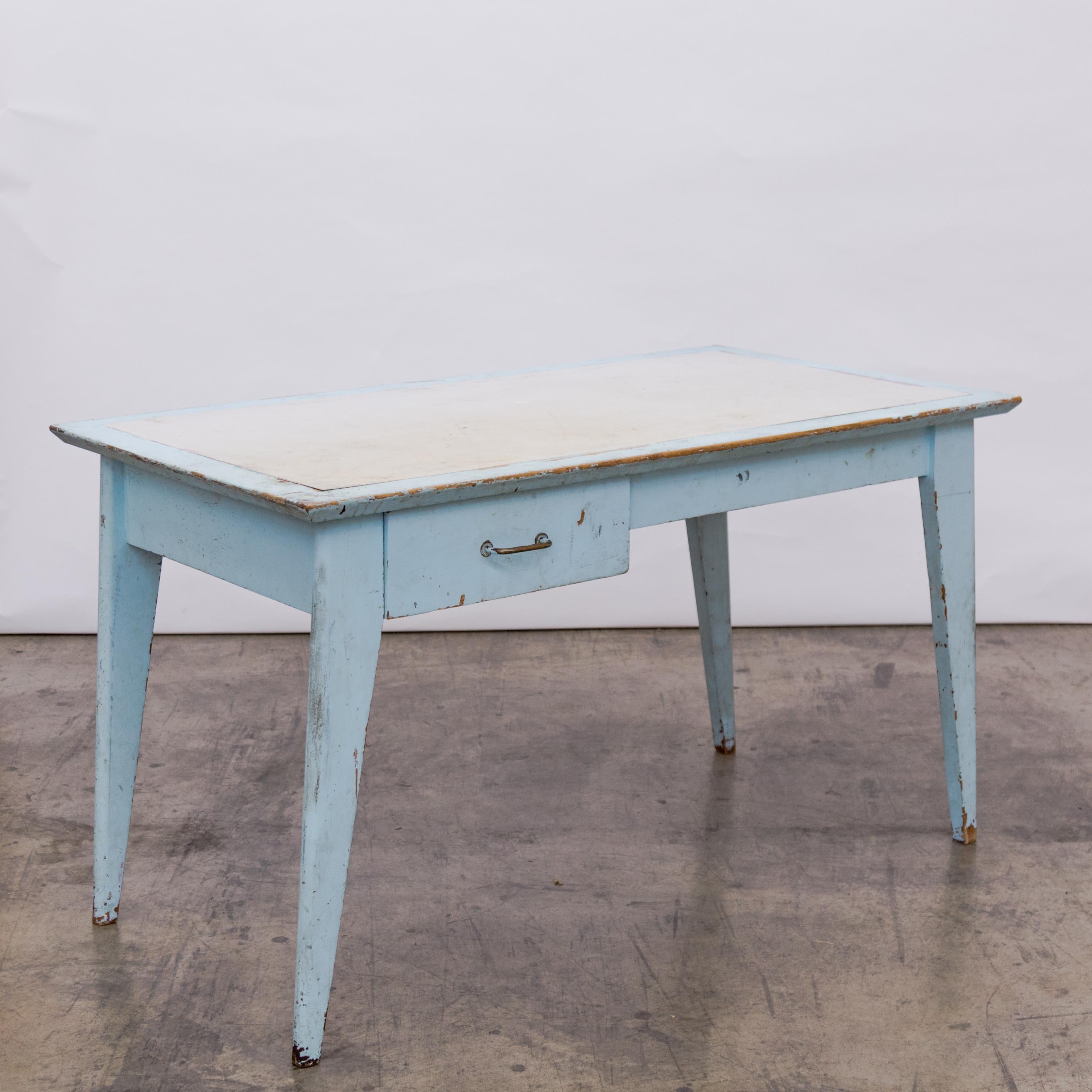 In the style of Jean Prouve a patinated eggshell blue student desk with single drawer and in inset white laminate top from the dormitories of the La Residence Universitaire Jean Zay, France circa 1950's.