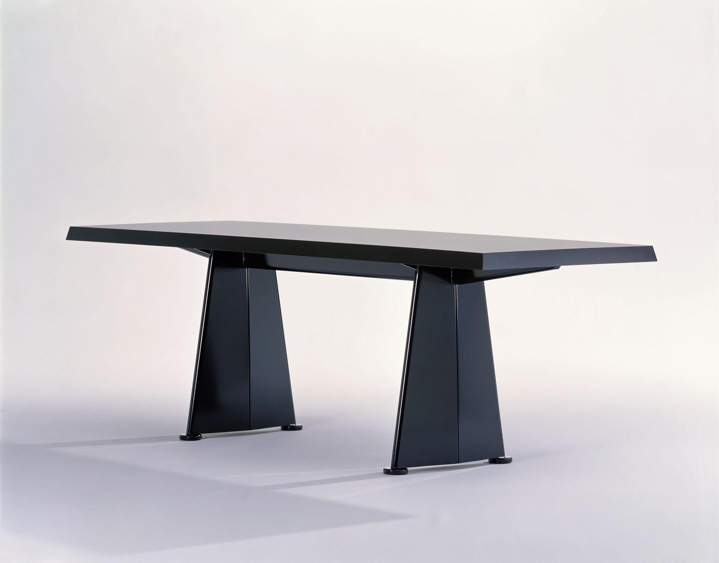 Table designed by Jean Prouvé in 1950/1954.
Manufactured by Vitra, Switzerland.

Jean Prouvé originally designed the Trapèze table for the Cité Universitaire in Antony near Paris. The trapezoidal shape of the sheet steel legs provided inspiration