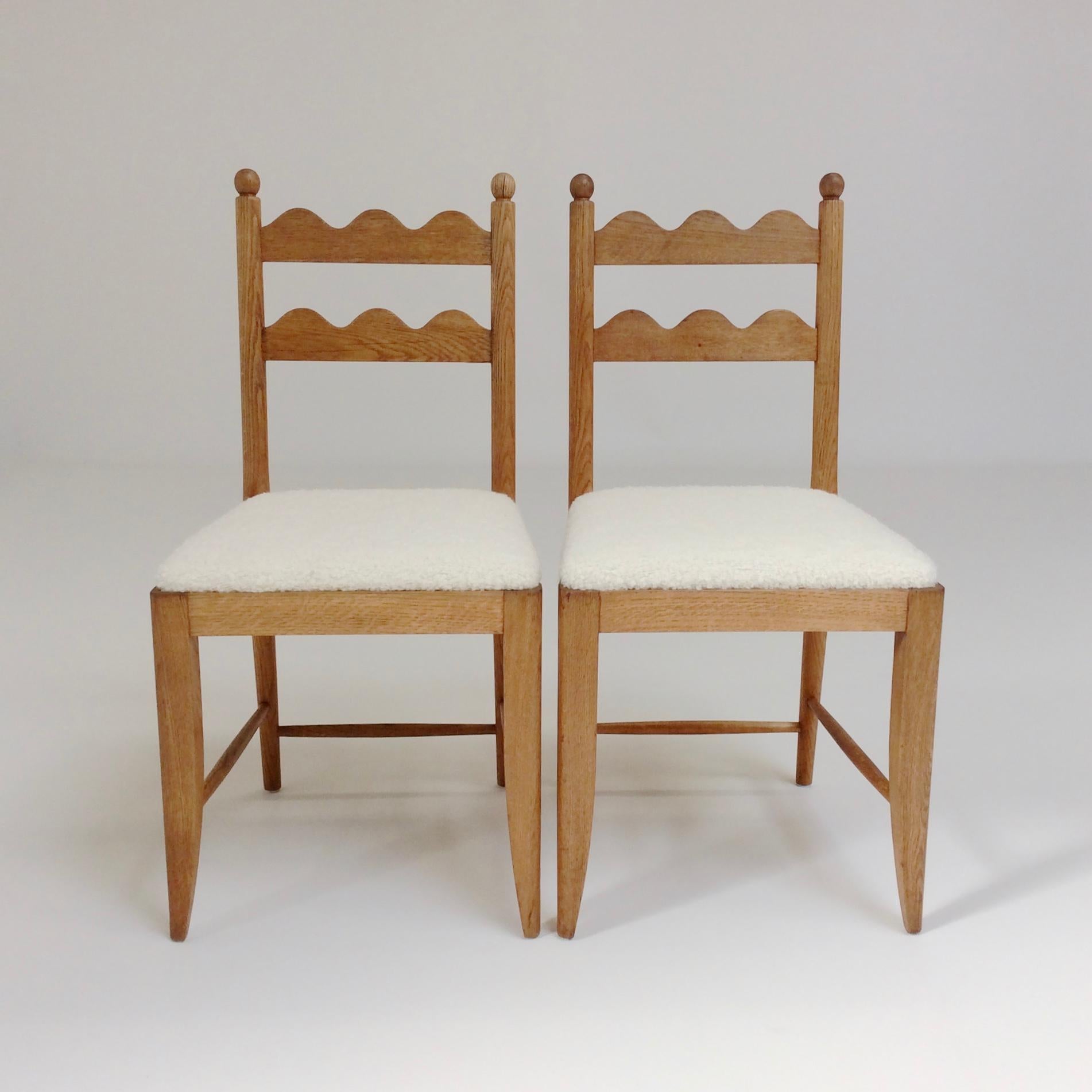 Beautiful and rare pair of Jean Royere attributed chairs, circa 1946, France.
Back with two decorative ondulations.
Solid oak, new ivory fabric seat.
Dimensions: 91 cm H, 44 cm W, 46 cm D, seat height 46 cm.
Documentation: similar chairs illustrated