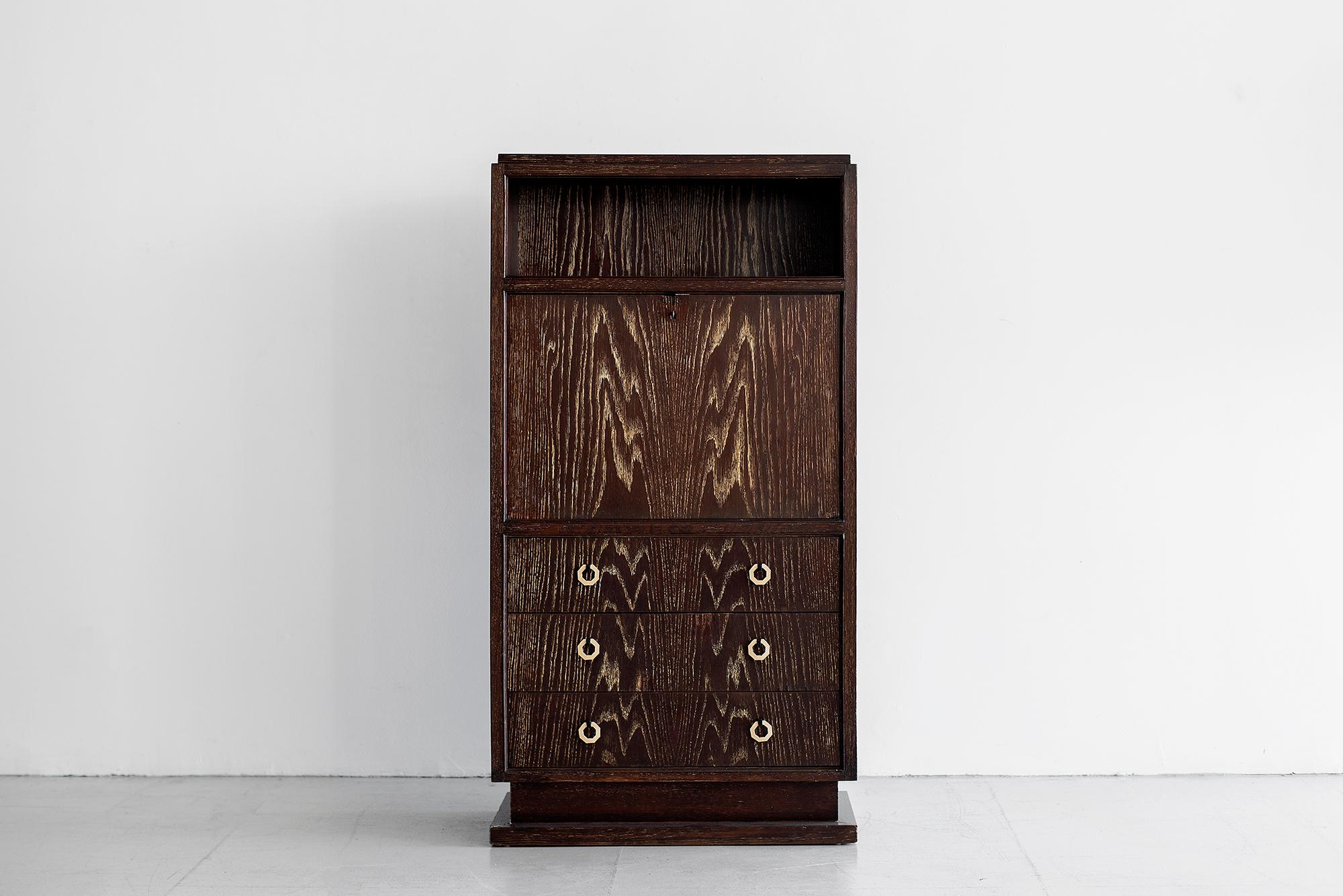 Wonderful secretary desk in cerused oak, France, 1930.
Rectangular cabinet with 3 drawers with white bakelite handles, 1 folding secretary drop down desk with 3 interior drawers, and a perforated upper shelf.
Incredible overall design and