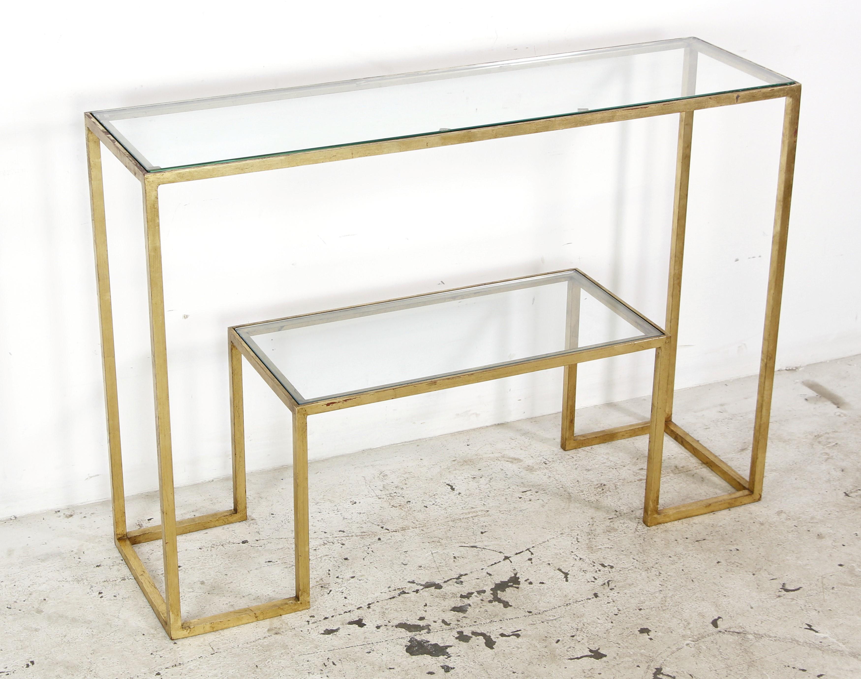 This French two tier console table is a Mid-Century Modern piece attributed to the renowned French designer Jean Royere, it embodies artistic innovation. This console table is gilded steel and with glass tiers. It is the style of European