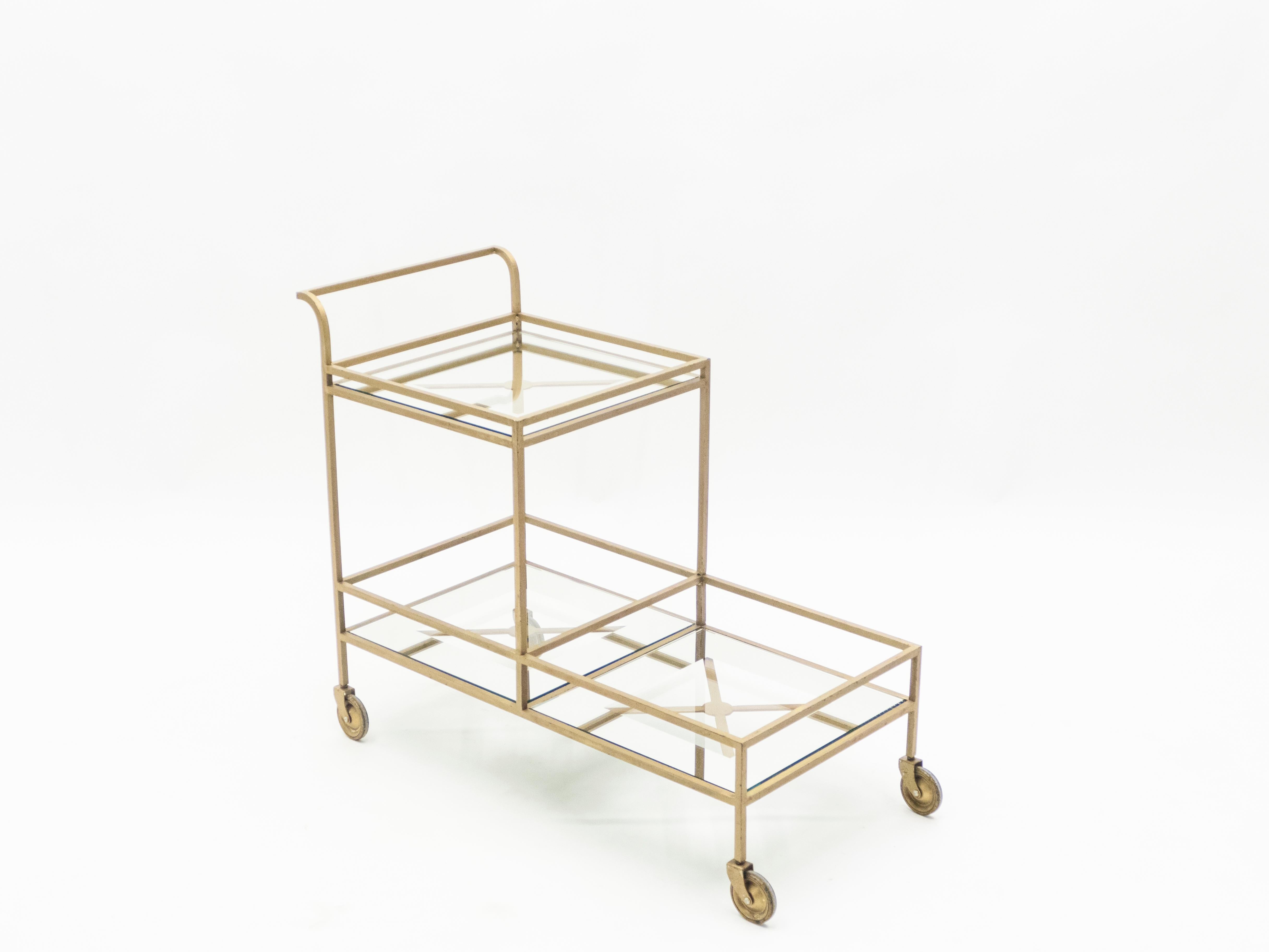 Rare and iconic serving trolley by Jean Royère in gilded metal with mirrored glass made circa 1950. Very good vintage condition with beautiful gilded patina.

Having opened a store in Paris in 1943 before the war had ended, Jean Royère was one of