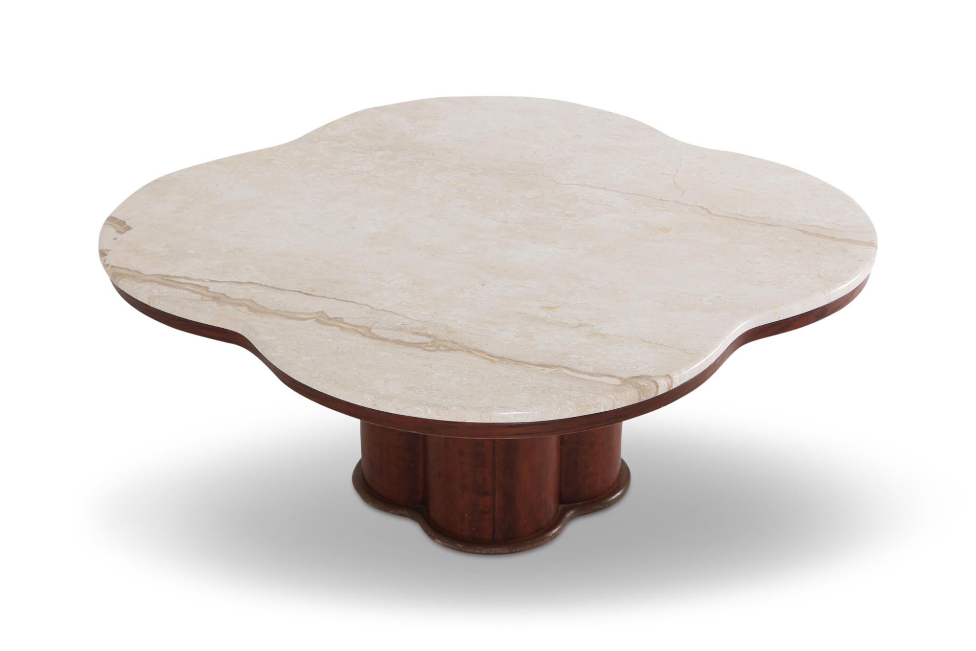 Mid-Century Modern, late Art Deco style coffee table with travertine top and walnut base
the clover shaped top and base make this a very elegant and organic design

Would fit as well in an eclectic Hollywood Regency inspired as in a Minimalist