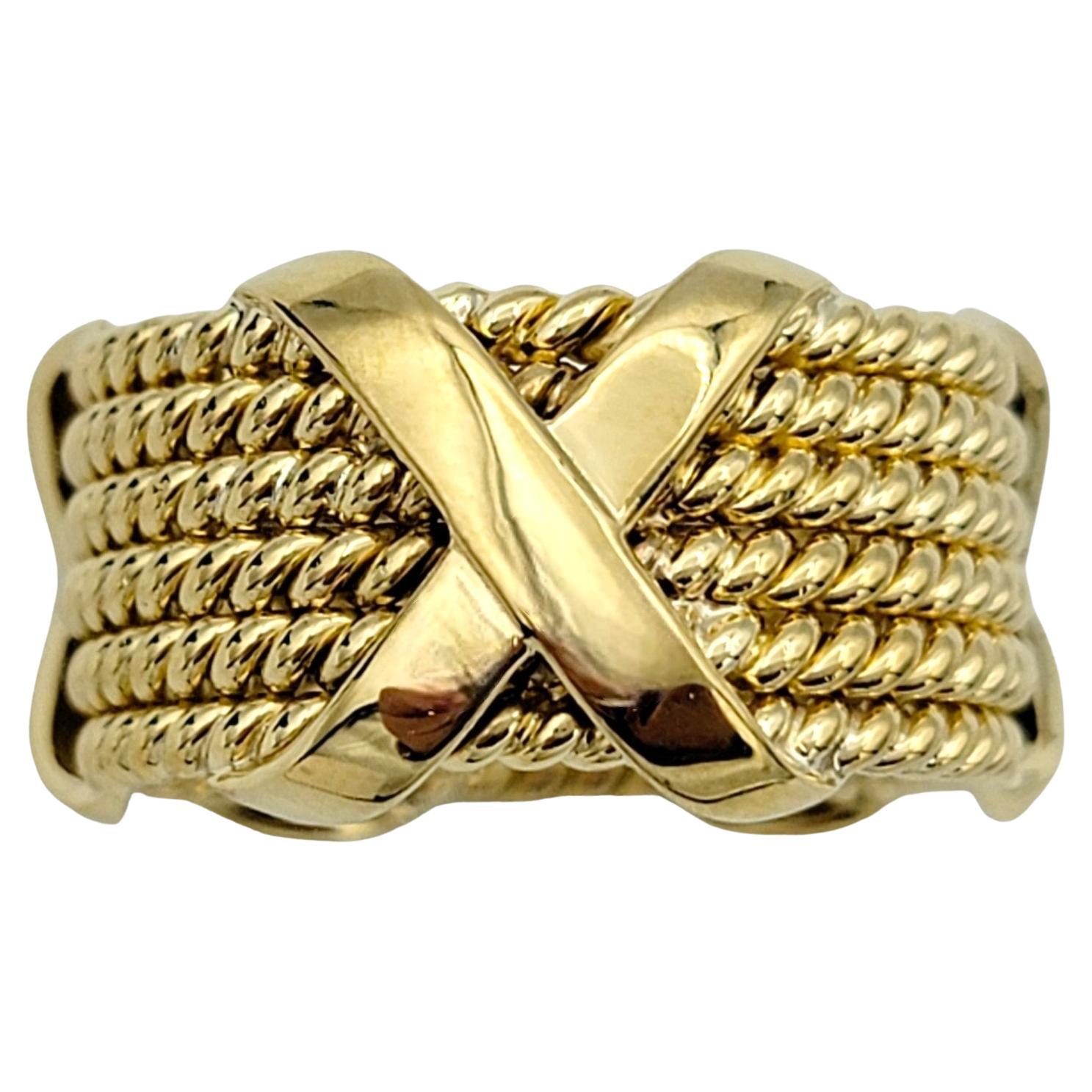 Ring Size: 8.5

Crafted with meticulous attention to detail, the Tiffany & Co. Schlumberger 6-row rope X design band ring exudes sophistication and timeless charm. Fashioned from 18 karat yellow gold, this exquisite ring features six intertwined