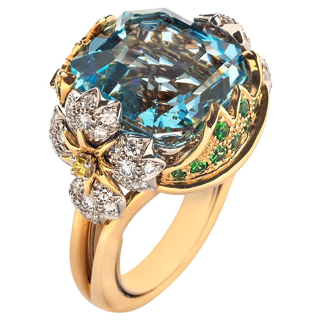 Jean Schlumberger was known for his masterful combination of color and form. This elegant cocktail ring centers on an icy blue aquamarine nestled between delicate diamond flowers and wrapped in tsavorite-encrusted leaves. 
 
Size 5-1/2 
One square