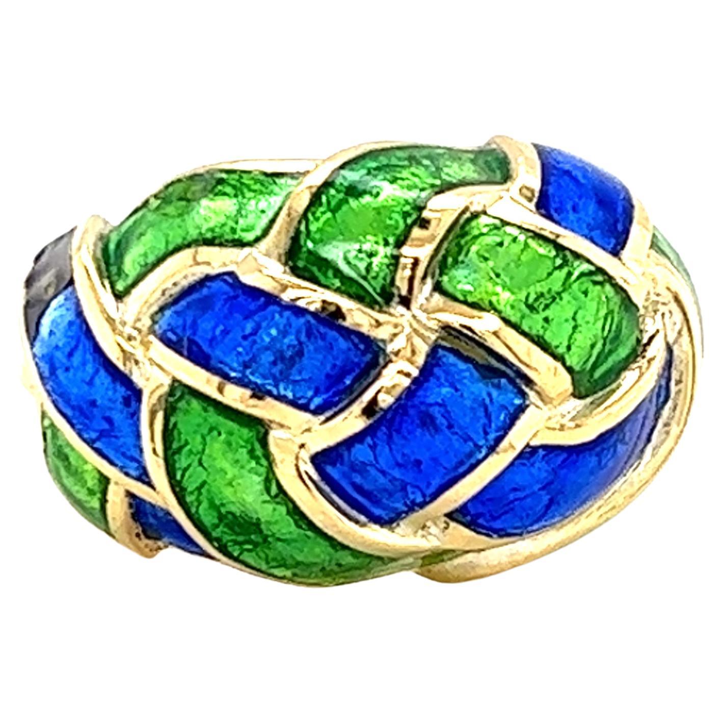 One 18 karat yellow gold glossed green and blue enamel woven knot dome ring, designed by Schlumberger for Tiffany & Co. One of the smallest side pieces of enamel has been repaired (see photos).  The ring is a finger size 7.5 and cannot be resized.