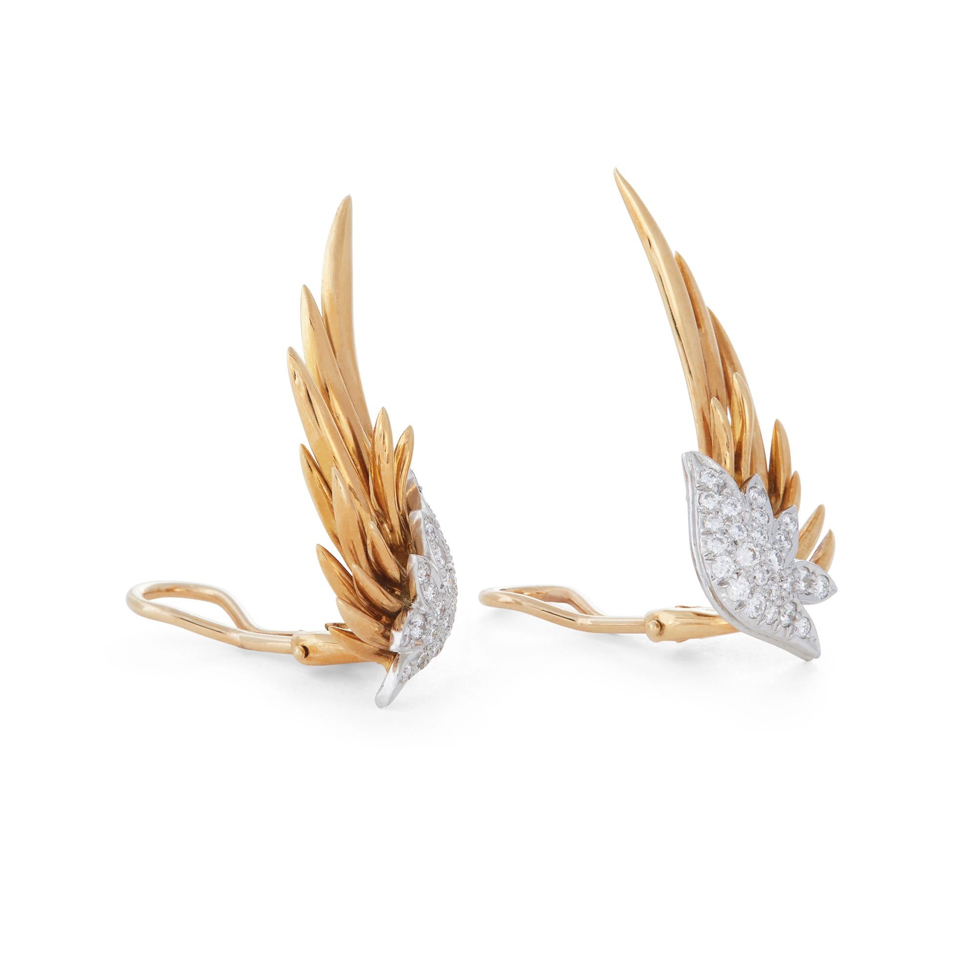 Authentic Jean Schlumberger for Tiffany & Co. Flame ear clips crafted in 18 karat yellow gold and platinum. Designed as flames and enhanced by round brilliant cut diamonds (G-H, VS) weighing an estimated 0.70 carats total.  The clips measure approx.