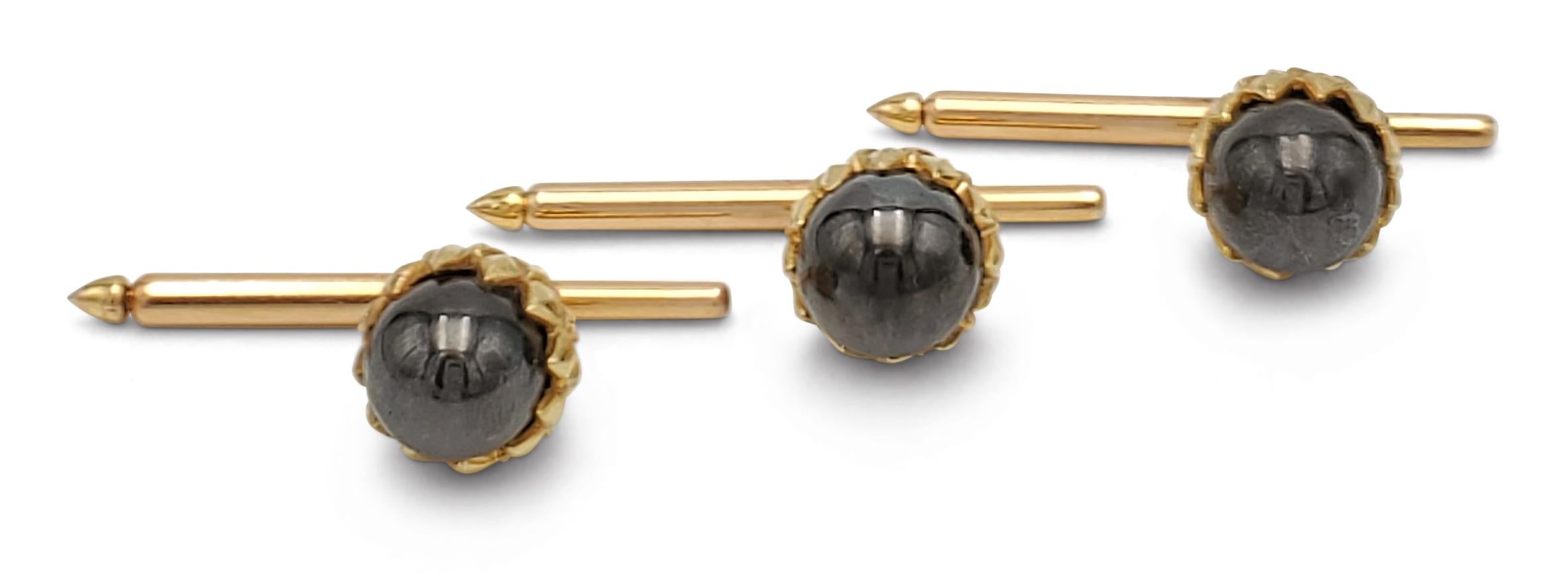 Authentic dress set created by Jean Schlumberger for Tiffany & Co. comprised of a pair of cufflinks and three dress studs. Each piece is designed as an acorn with a hematite sphere covered with gold leaves. Each cufflink measures 1/2 inch, shirt