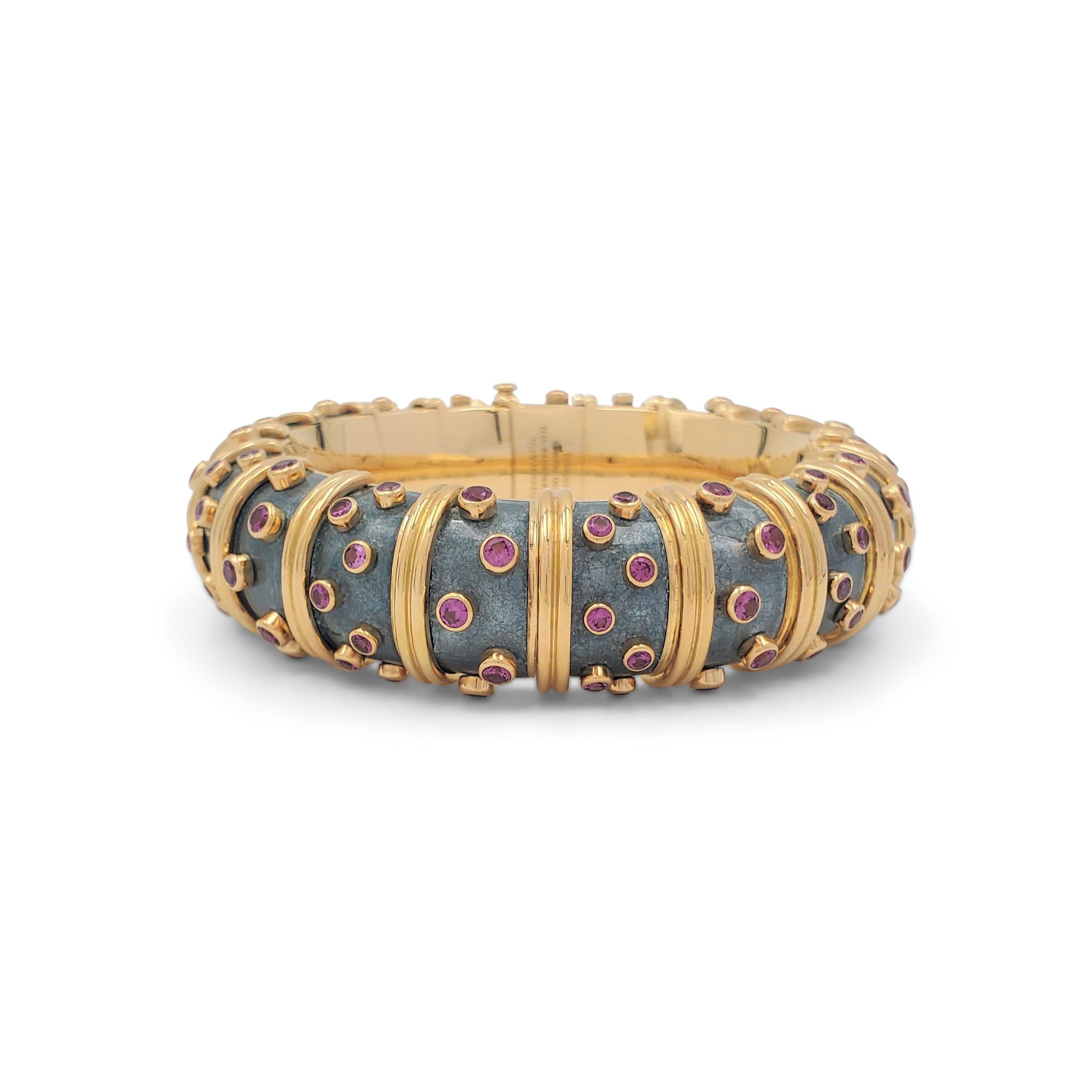 An iconic 'Jackie' bracelet designed by Jean Schlumberger for Tiffany & Co. The articulated link bombe bracelet is crafted in 18 karat yellow gold and features a rare color combination of slate gray paillonné enamel which is accented by raised round