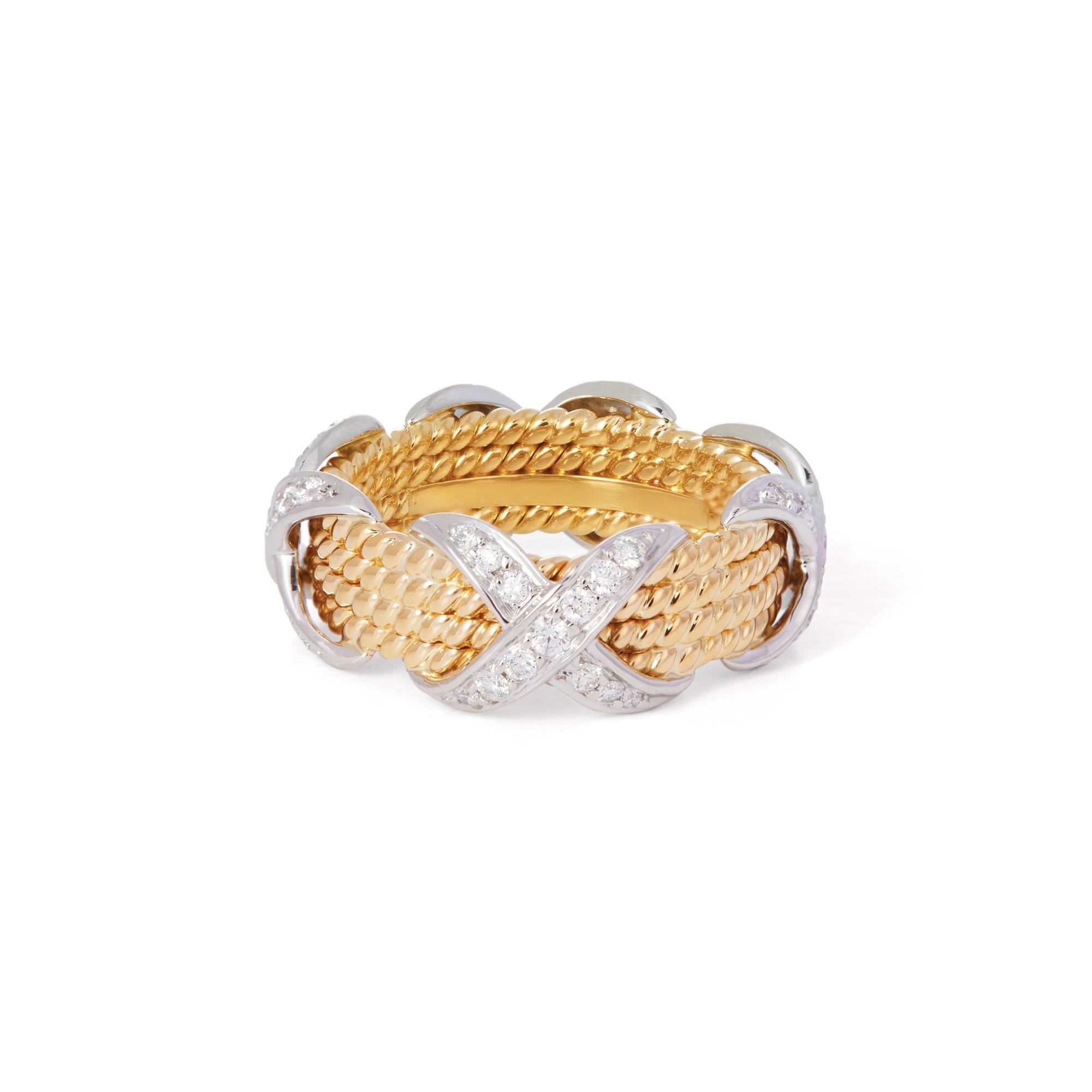 Authentic Jean Schlumberger for Tiffany & Co. ring crafted in roped 18 karat yellow gold featuring four 'x' designs. The 'x' designs are made in platinum and set with an estimated 0.50 carats of high-quality round brilliant cut diamonds. Signed