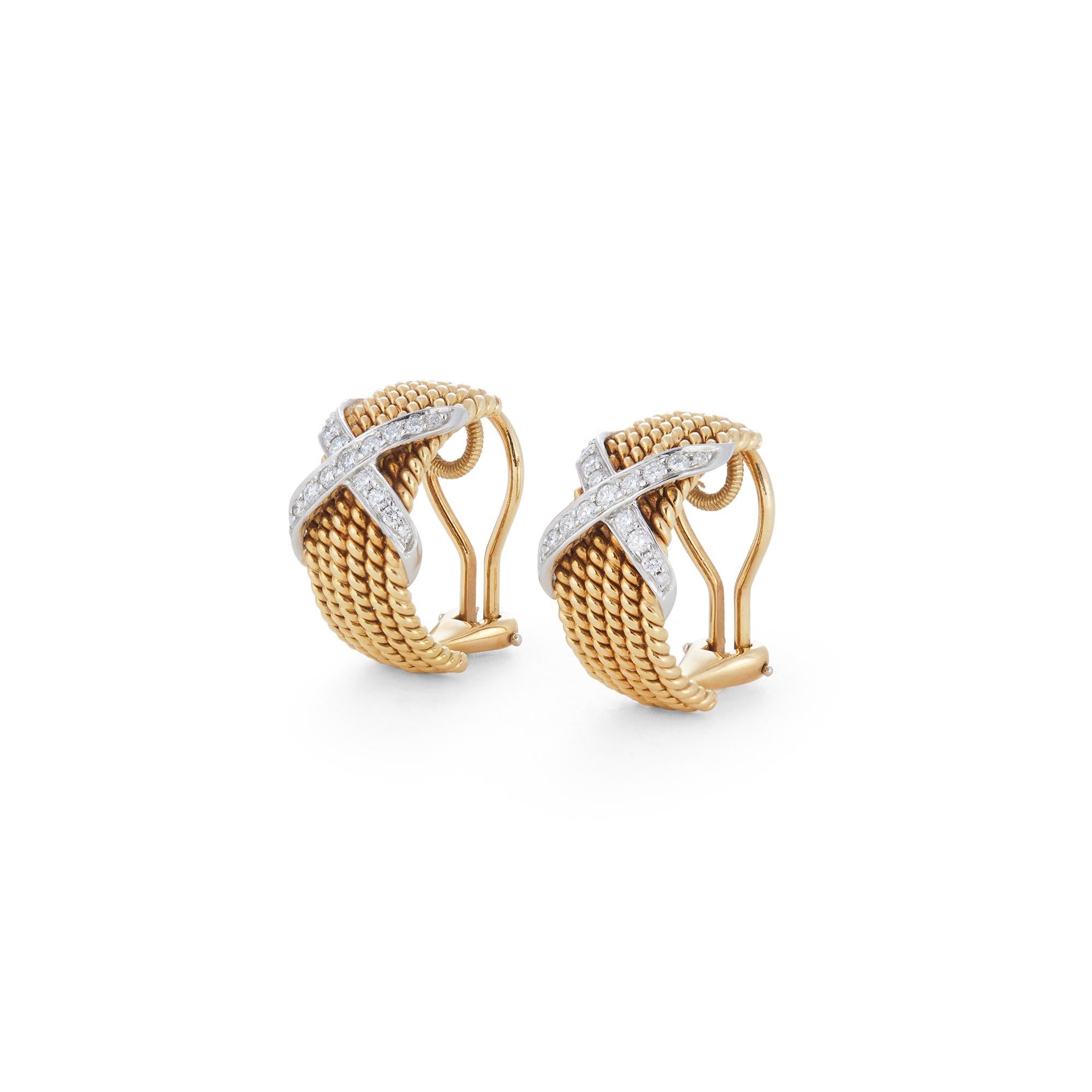 Authentic Jean Schlumberger for Tiffany & Co. ear clips designed as demi-hoops of roped 18 karat yellow gold surmounted by platinum 'X' accents set with 34 round brilliant cut diamonds (G-H, VS) weighing an estimated 0.50 carats total. The clips
